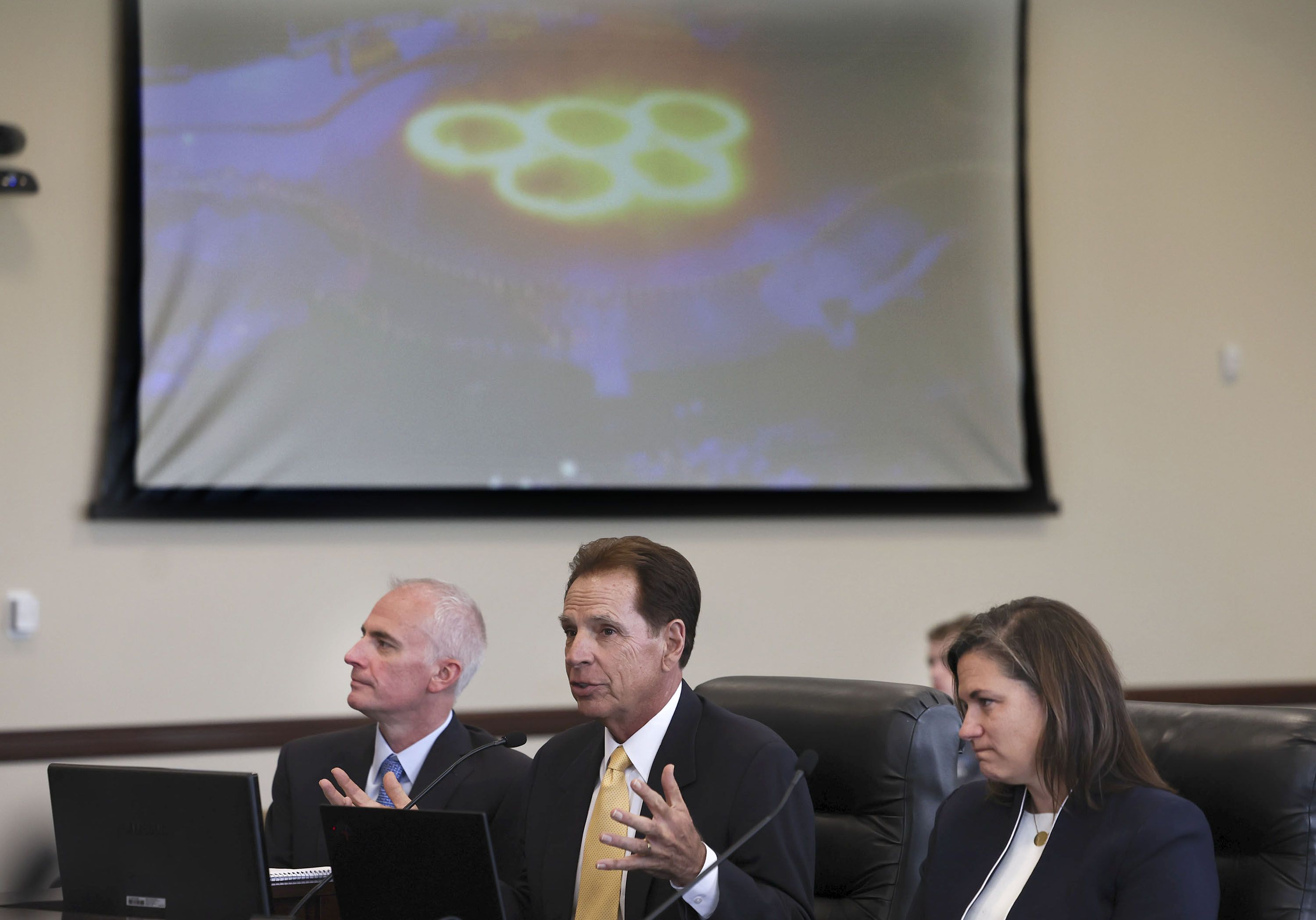 Darren Hughes, bid lead for the Salt Lake City-Utah Committee for the Games, left, Fraser Bullock, committee president and CEO, and Catherine Raney Norman, committee chairwoman, speak during the first meeting of Utah Legislature’s Olympic Coordination Committee at the Capitol in Salt Lake City on Thursday.