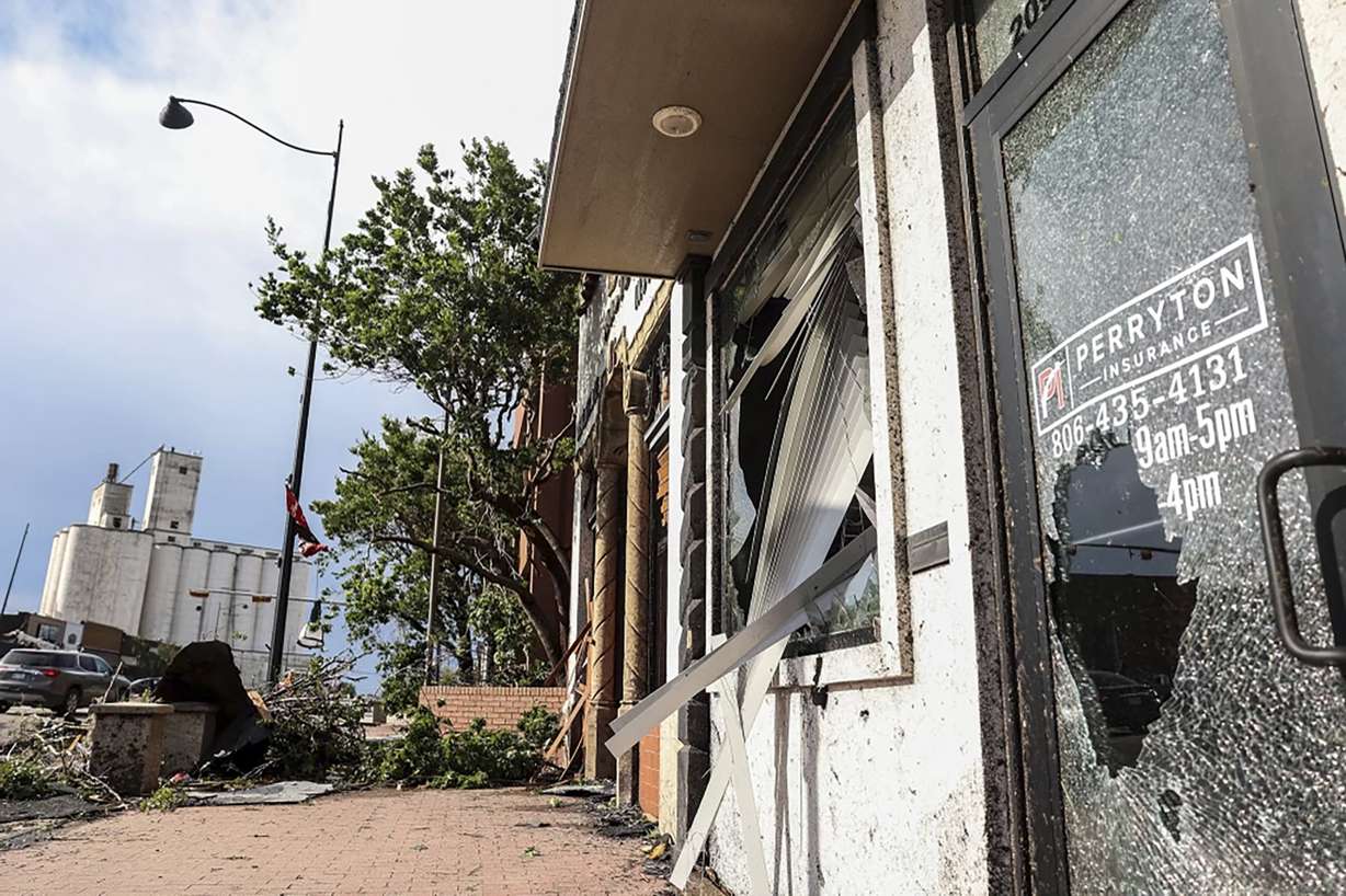 Stores in downtown Perryton, Texas, show damage after a tornado passed through the region, Thursday.