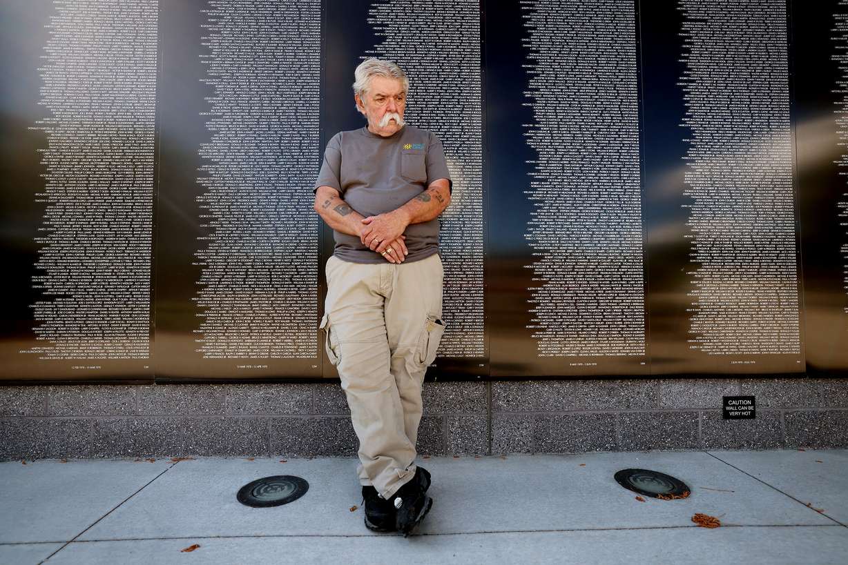 Military veteran Terry McDade, an engineering technician in the Ogden Air Logistics Complex's 309th Aircraft Maintenance Group, recently received national recognition for his achievements in disability employment. McDade poses for photos at Layton's Vietnam Memorial Wall replica on Tuesday.