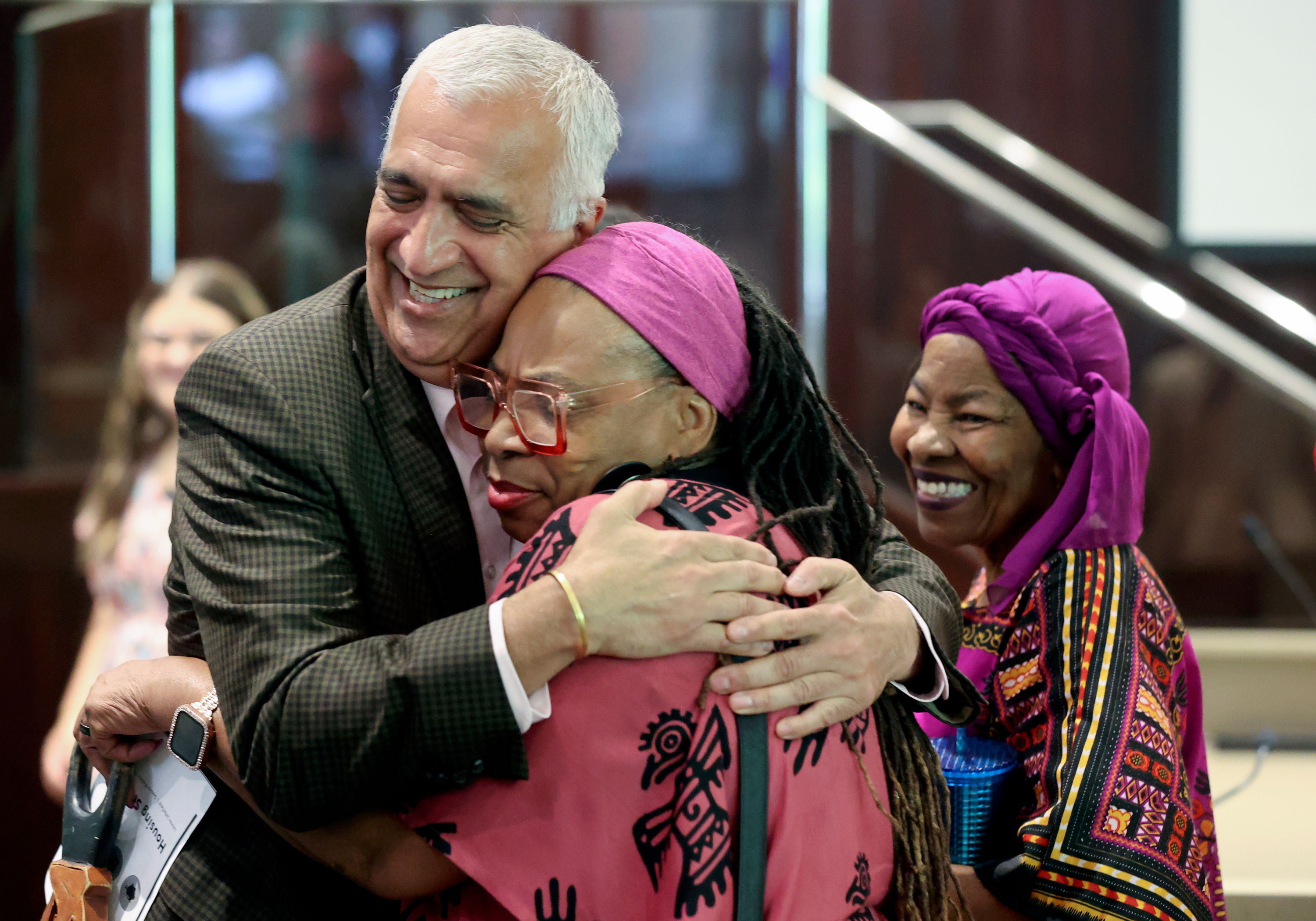 Salt Lake County District Attorney Sim Gill hugs Betty Sawyer, Project Success director, during a Juneteenth celebration at the Salt Lake County Government Center in Salt Lake City on Friday.