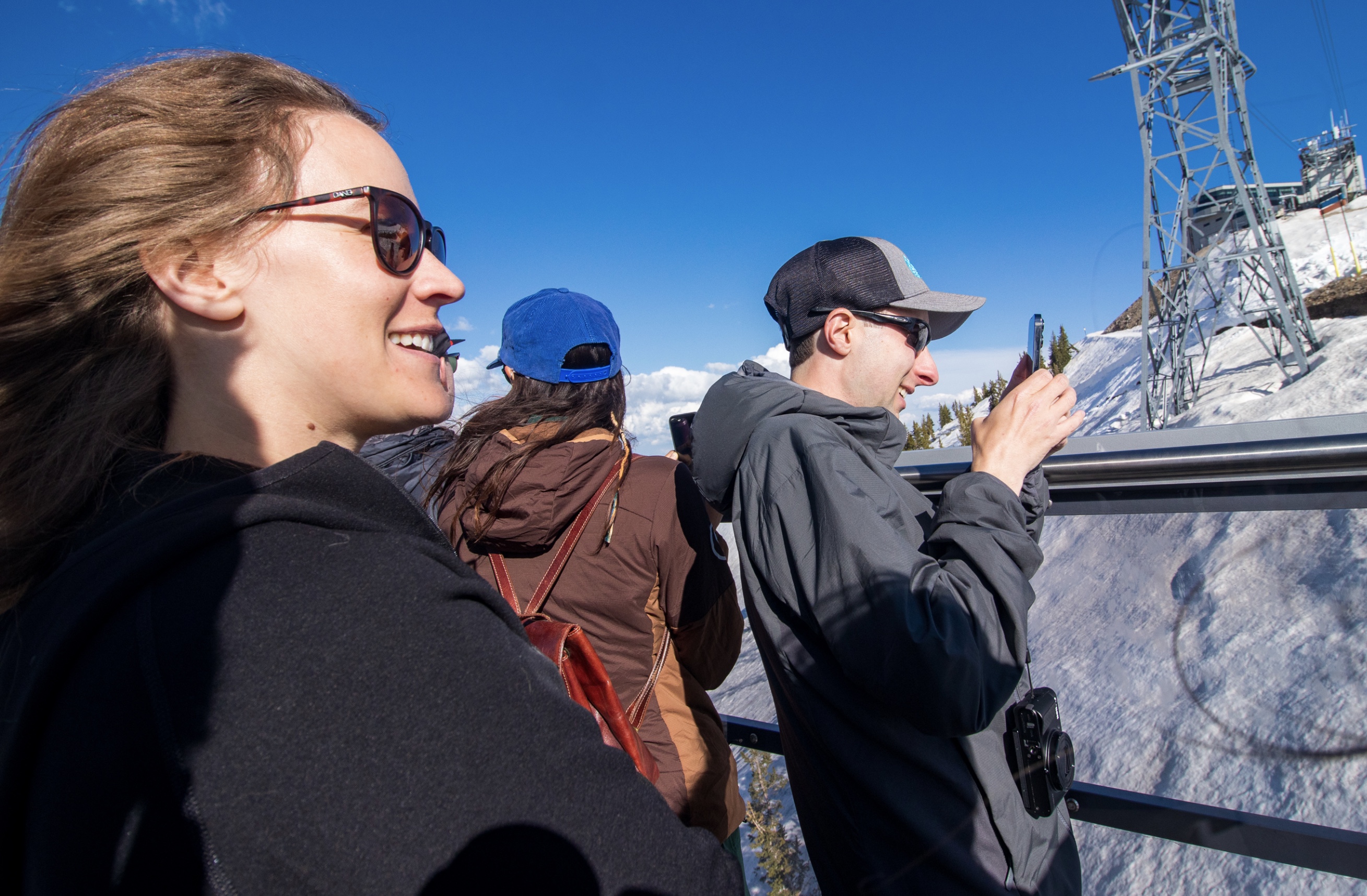 Snowbird Resort spokeswoman Sarah Sherman, left, rides the resort's tram from its outdoor balcony Friday evening. The balcony will be available to tram riders beginning Saturday