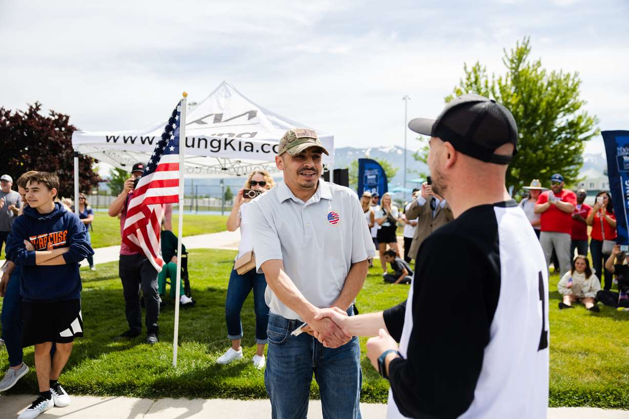 Retired U.S. Army Sgt. William Davis III accepts the keys to a new car at Ellison Park in Layton on Saturday.