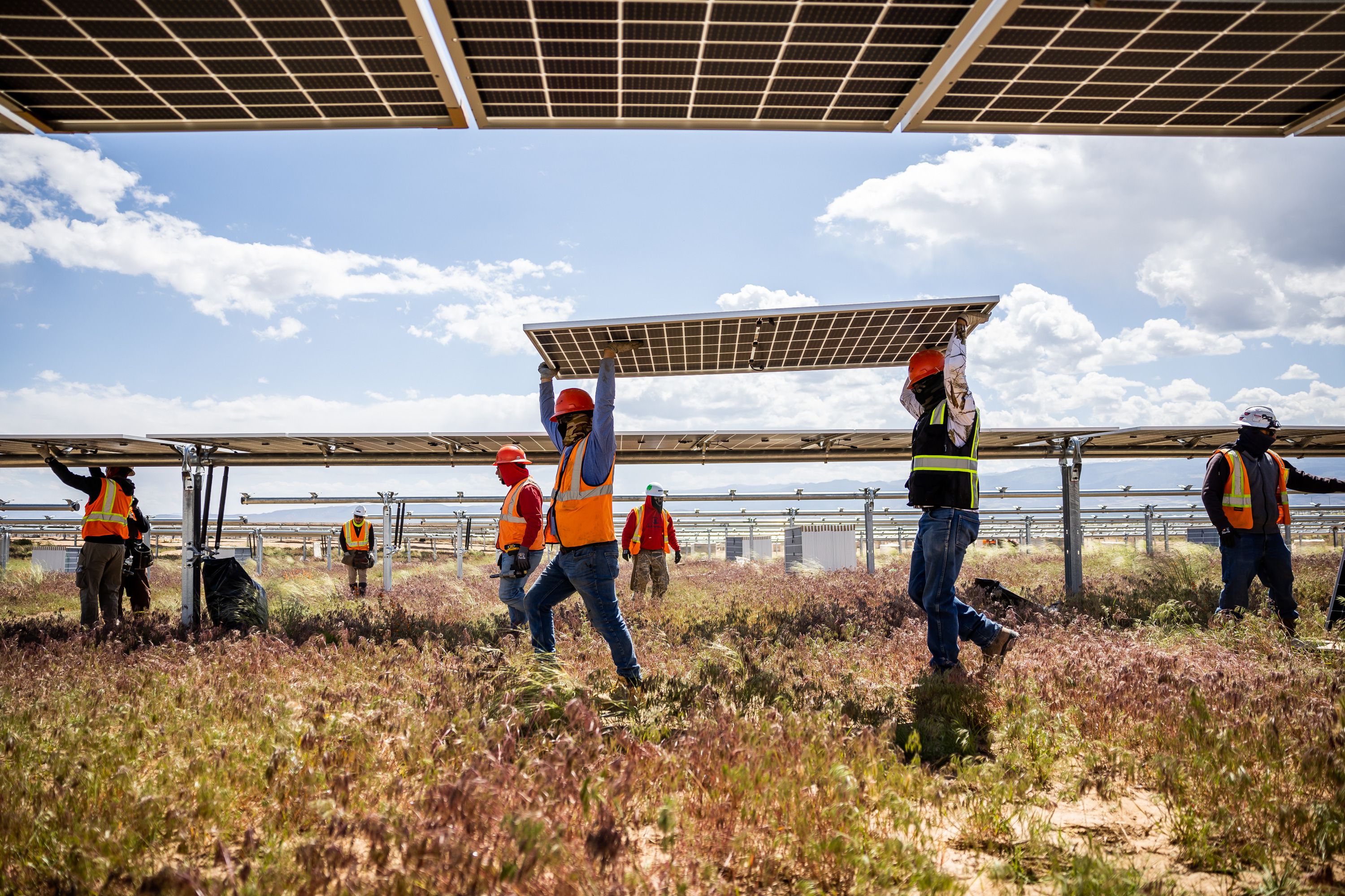 Crews work to install photovoltaic panels on racking at the Appaloosa Solar 1 project near Cedar City on June 8. rPlus Energies has solar fields in Carbon and Iron counties and is pursuing a pumped storage hydropower project in Utah.