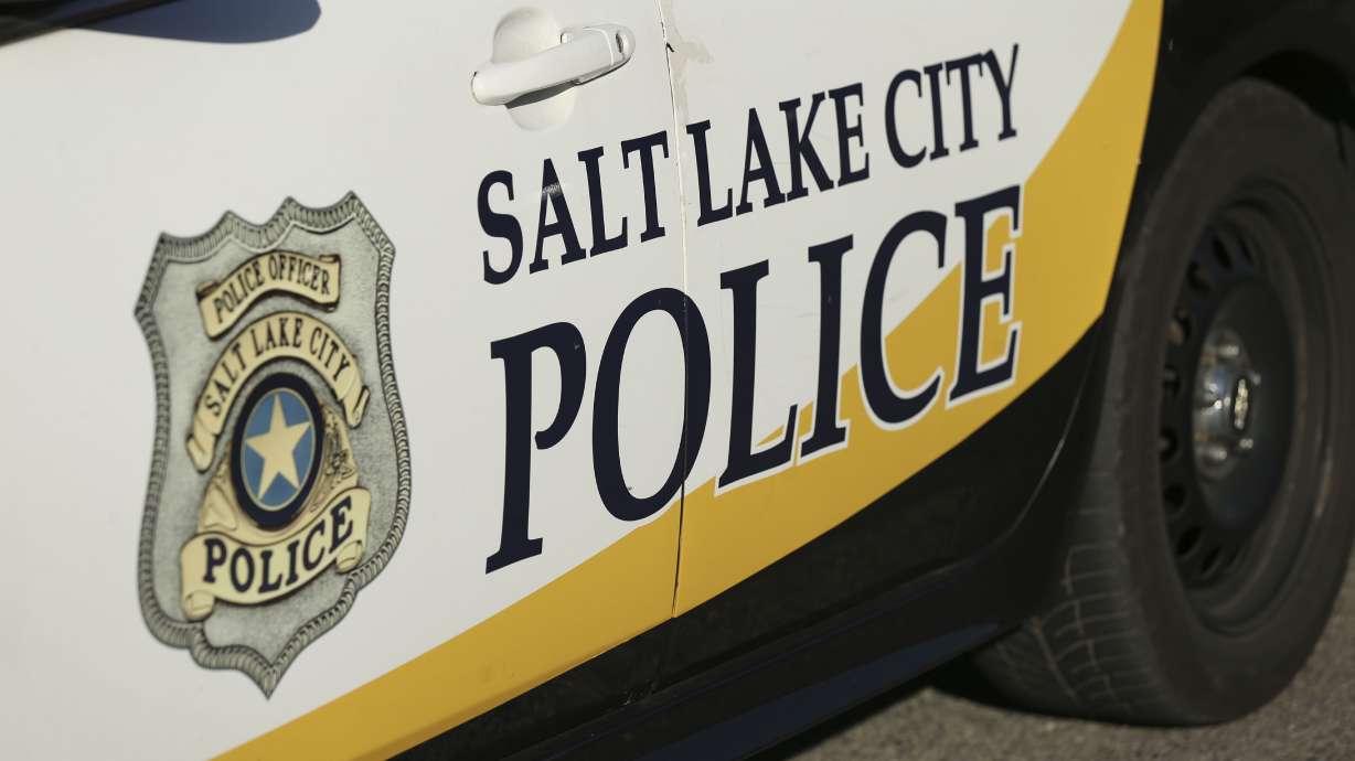 A woman was arrested Thursday after police say he held a teen boy against his will while riding a TRAX train and then threatened other passengers who tried to help the boy.
