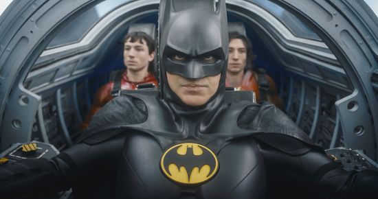 This image shows Ezra Miller, from left, Michael Keaton as Batman and Ezra Miller in a scene from "The Flash."