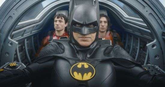 This image shows Ezra Miller, from left, Michael Keaton as Batman and Ezra Miller in a scene from "The Flash."