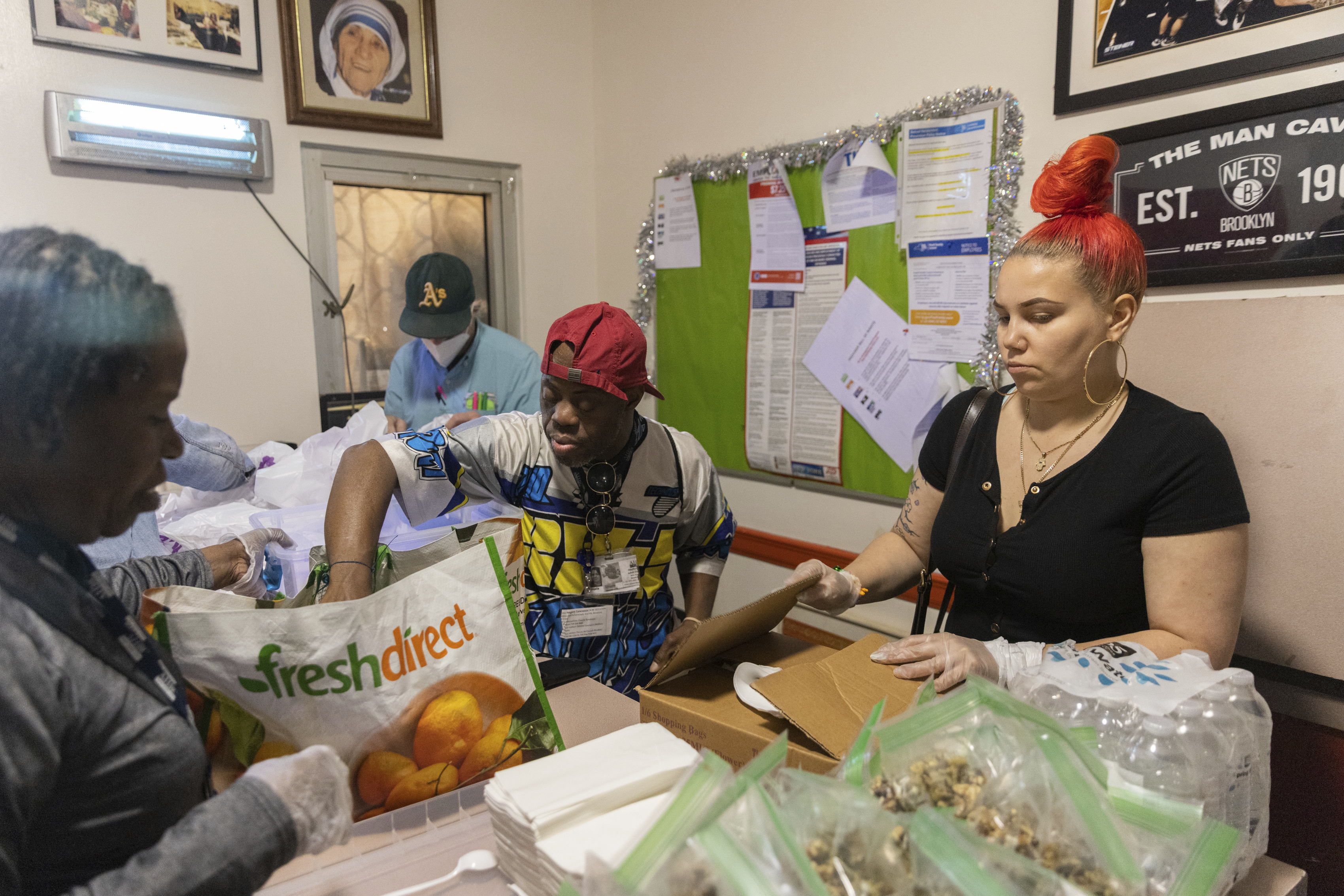 Angela Bagriy, right, organizes lunch boxes at Community Help in Park Slope, a soup kitchen and food pantry better known as CHiPS, on Friday in New York. Charitable giving in the United States declined in 2022. The downturn in giving has led to issues at CHiPS, as it has in many charities across the country.