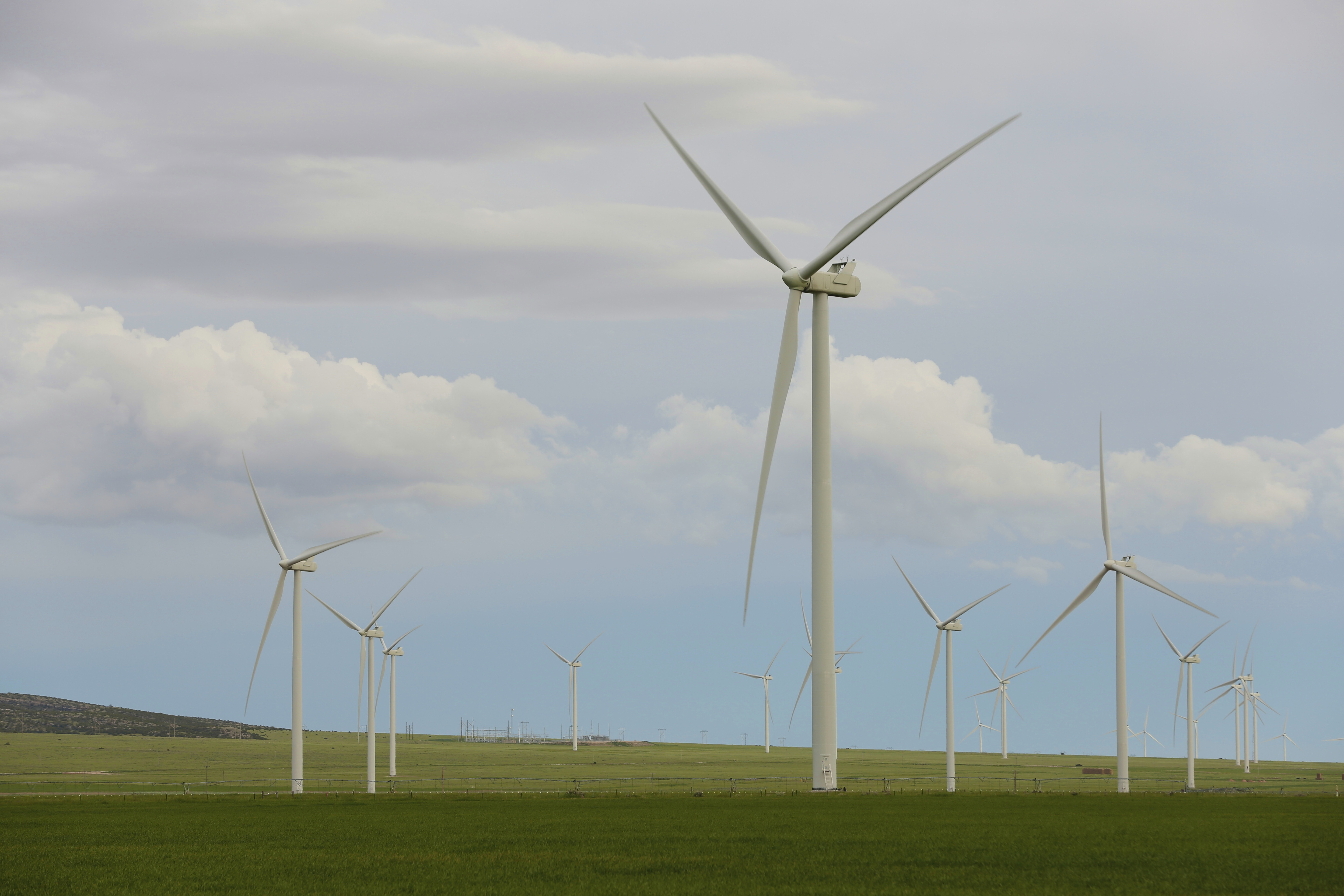 Wind turbines stand at a wind farm along the Montana-Wyoming state line on June 13, 2022. Wyoming and federal officials will formally kick off construction Tuesday of a massive transmission line project to export wind power from Wyoming to southern California.