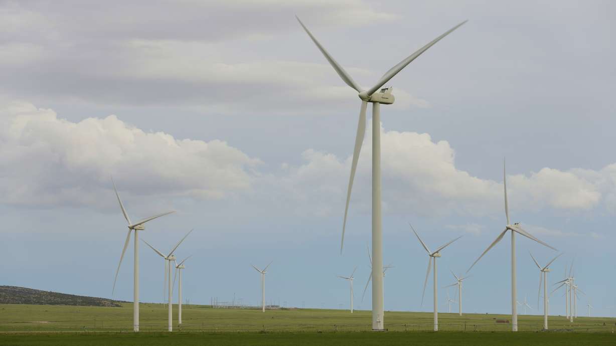 Wind turbines stand at a wind farm along the Montana-Wyoming state line on June 13, 2022. Wyoming and federal officials will formally kick off construction Tuesday of a massive transmission line project to export wind power from Wyoming to southern California.