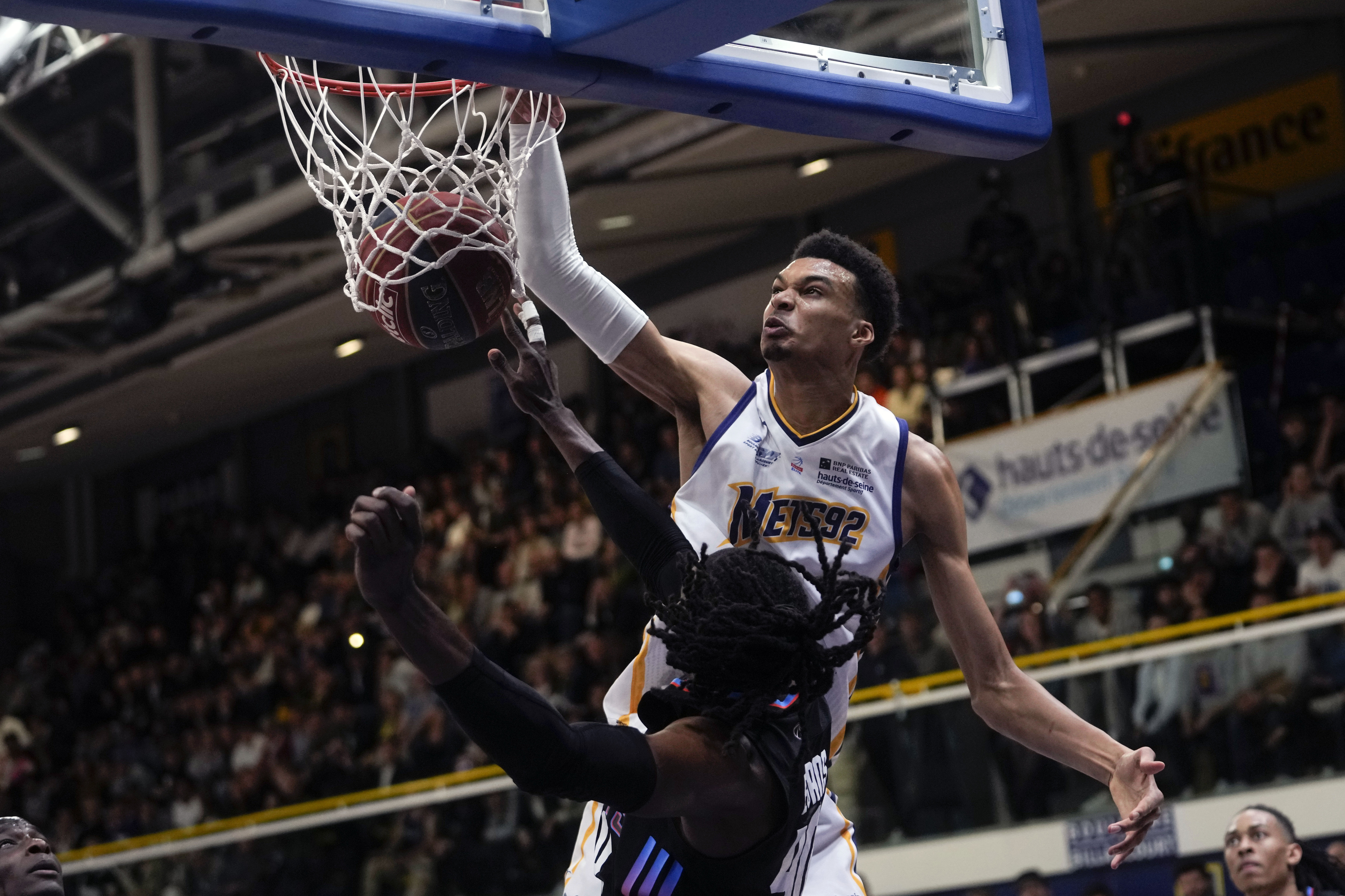 FILE - Boulogne-Levallois' Victor Wembanyama, top, dunks during the Elite basketball match Boulogne-Levallois against Paris at the Palais de Sports Marcel Cerdan stadium in Levallois-Perret, outside Paris, May 16, 2023. Wembanyam is among the headliners among the top big men in the upcoming NBA draft. 