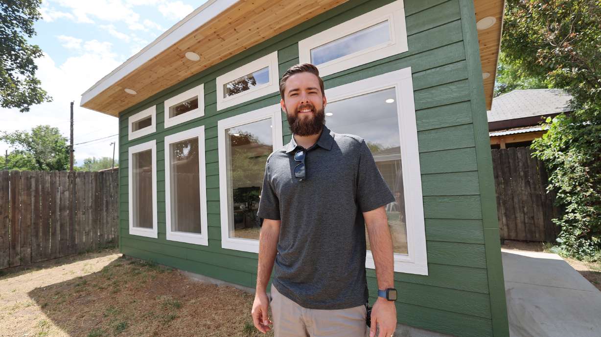Jonathan Hitzhusen, owner of Backyard Office Utah, poses for a photo on June 20, in Midvale, while standing in the backyard of client Sydney Jones.