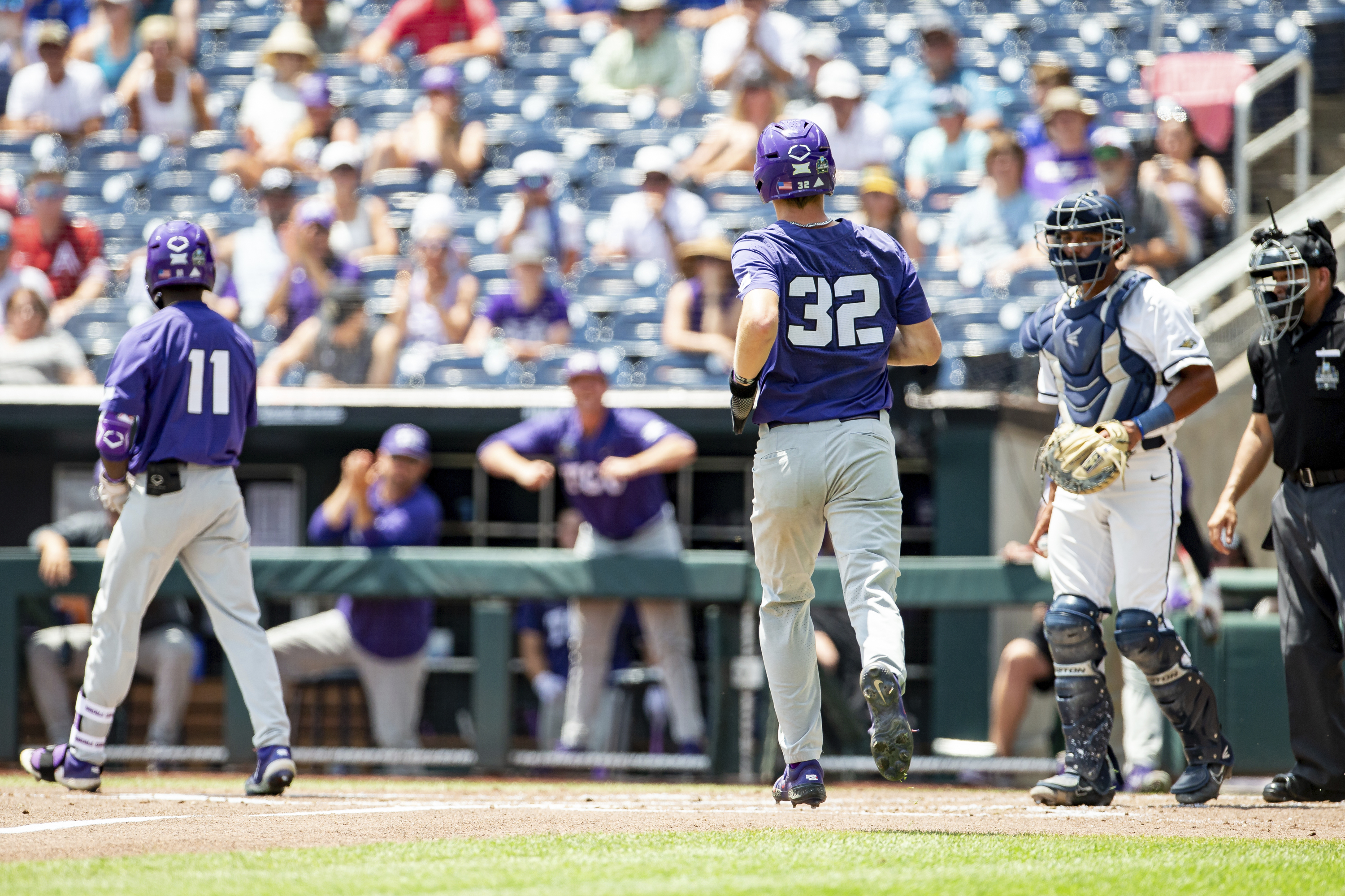 TCU base runner Cole Fontenelle (32) scores a run in the second inning against Oral Roberts in a baseball game at the NCAA College World Series in Omaha, Neb., Tuesday, June 20, 2023. 