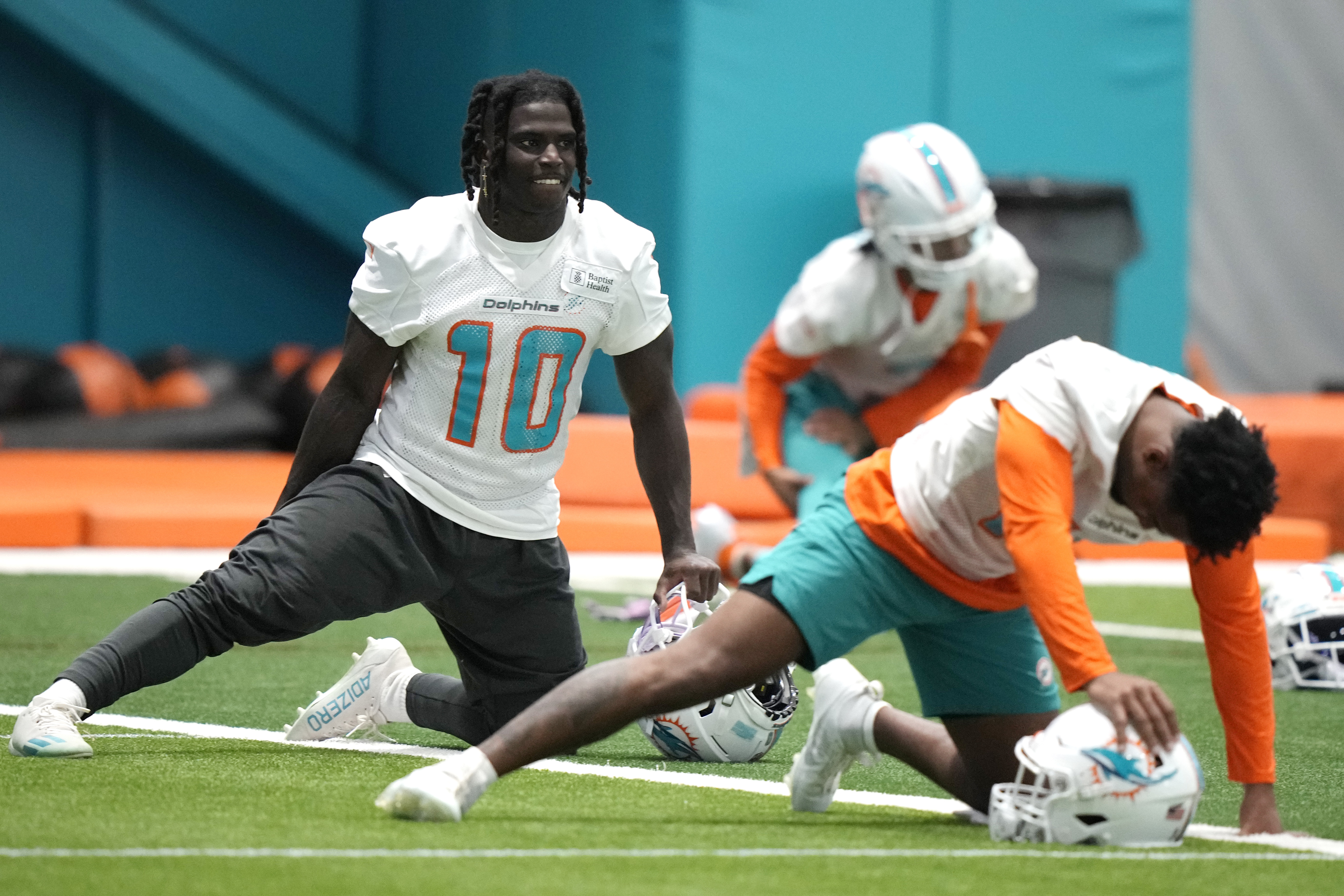 Miami Dolphins wide receiver Tyreek Hill (10) stretches during practice at the NFL football team's training facility, Tuesday, June 6, 2023, in Miami Gardens, Fla. 