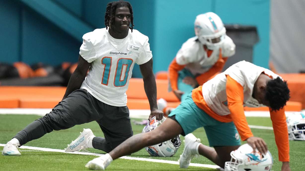 Miami Dolphins wide receiver Tyreek Hill (10) stretches during practice at the NFL football team's training facility, Tuesday, June 6, 2023, in Miami Gardens, Fla.