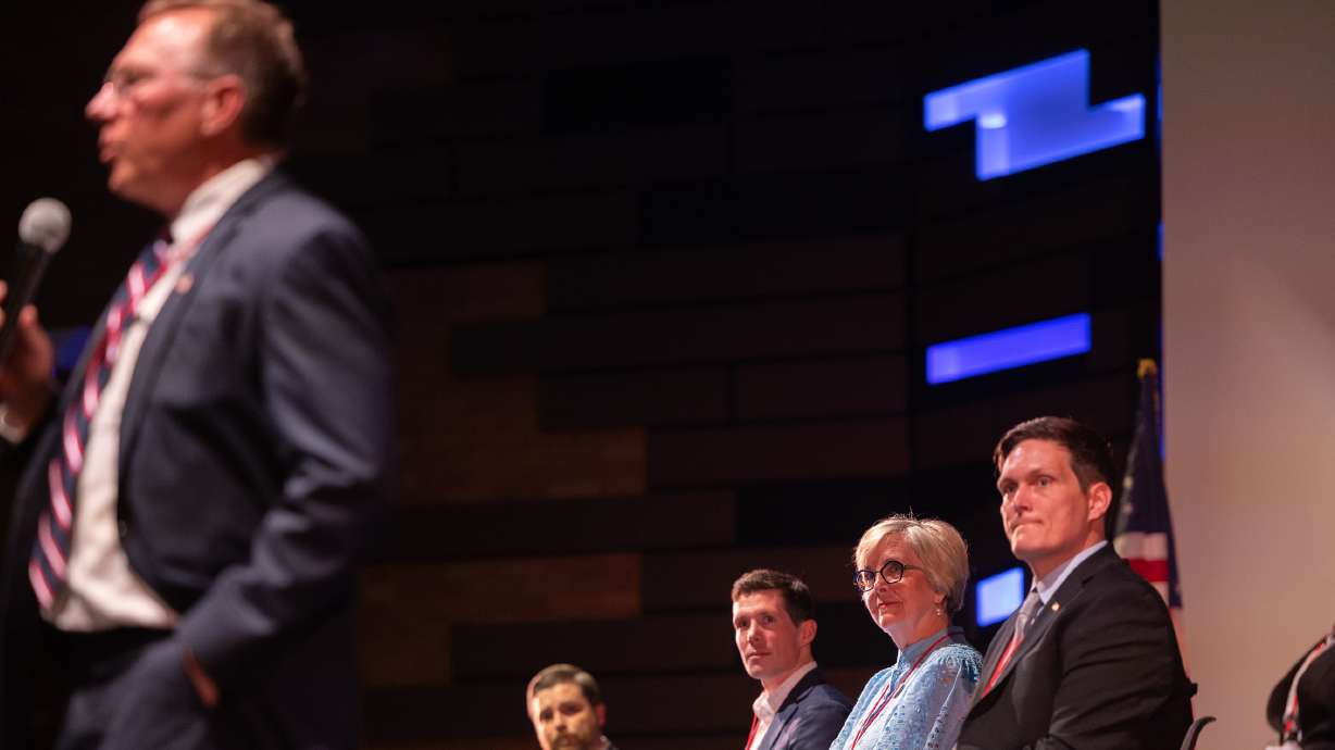 Utah Congressional District 2 representative candidates listen as Bill Hoster speaks during the first Congressional District 2 debate at Woods Cross High School in Woods Cross on Tuesday.