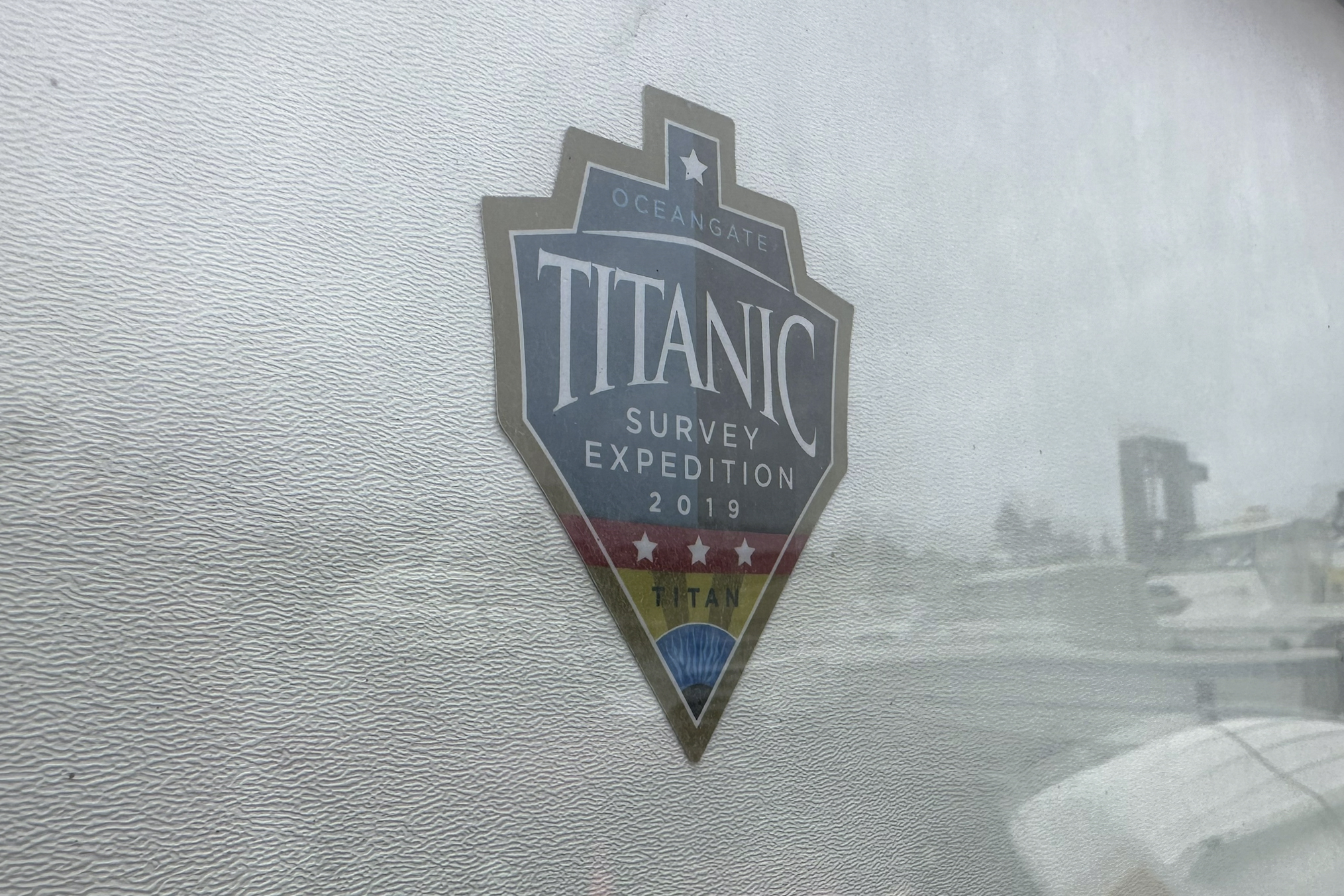 The logo for an OceanGate Expeditions 2019 Titanic expedition is seen on a marine industrial warehouse office door in Everett, Wash., Tuesday. Rescuers are racing against time to find the missing submersible carrying five people, who were reported overdue Sunday night.