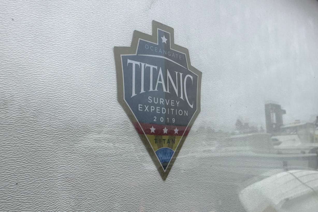 The logo for an OceanGate Expeditions 2019 Titanic expedition is seen on a marine industrial warehouse office door in Everett, Wash., Tuesday. Rescuers are racing against time to find the missing submersible carrying five people, who were reported overdue Sunday night.