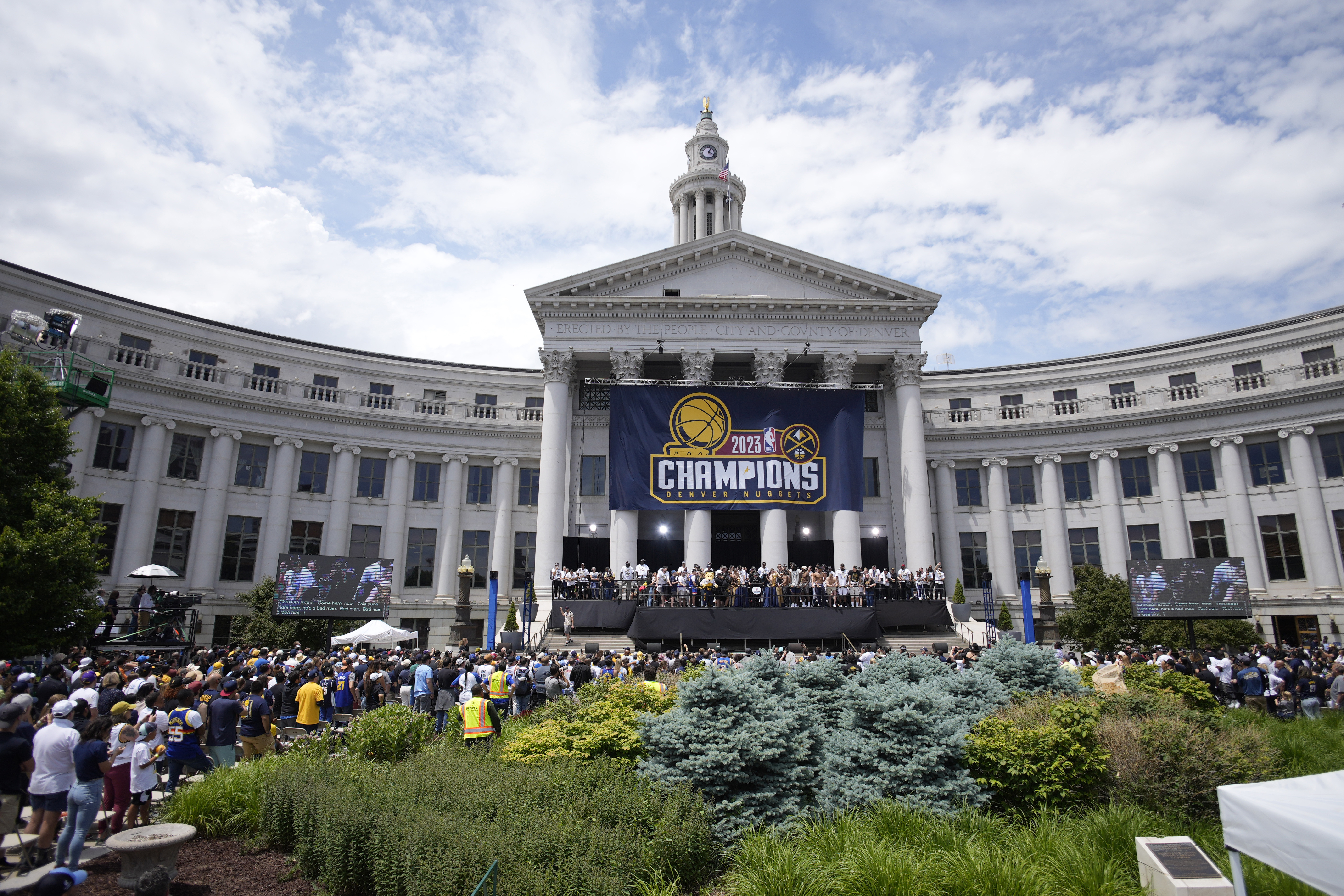 Members of the Denver Nuggets crowd the stage during a rally and parade to mark the team's first NBA basketball championship on Thursday, June 15, 2023, in Denver. 