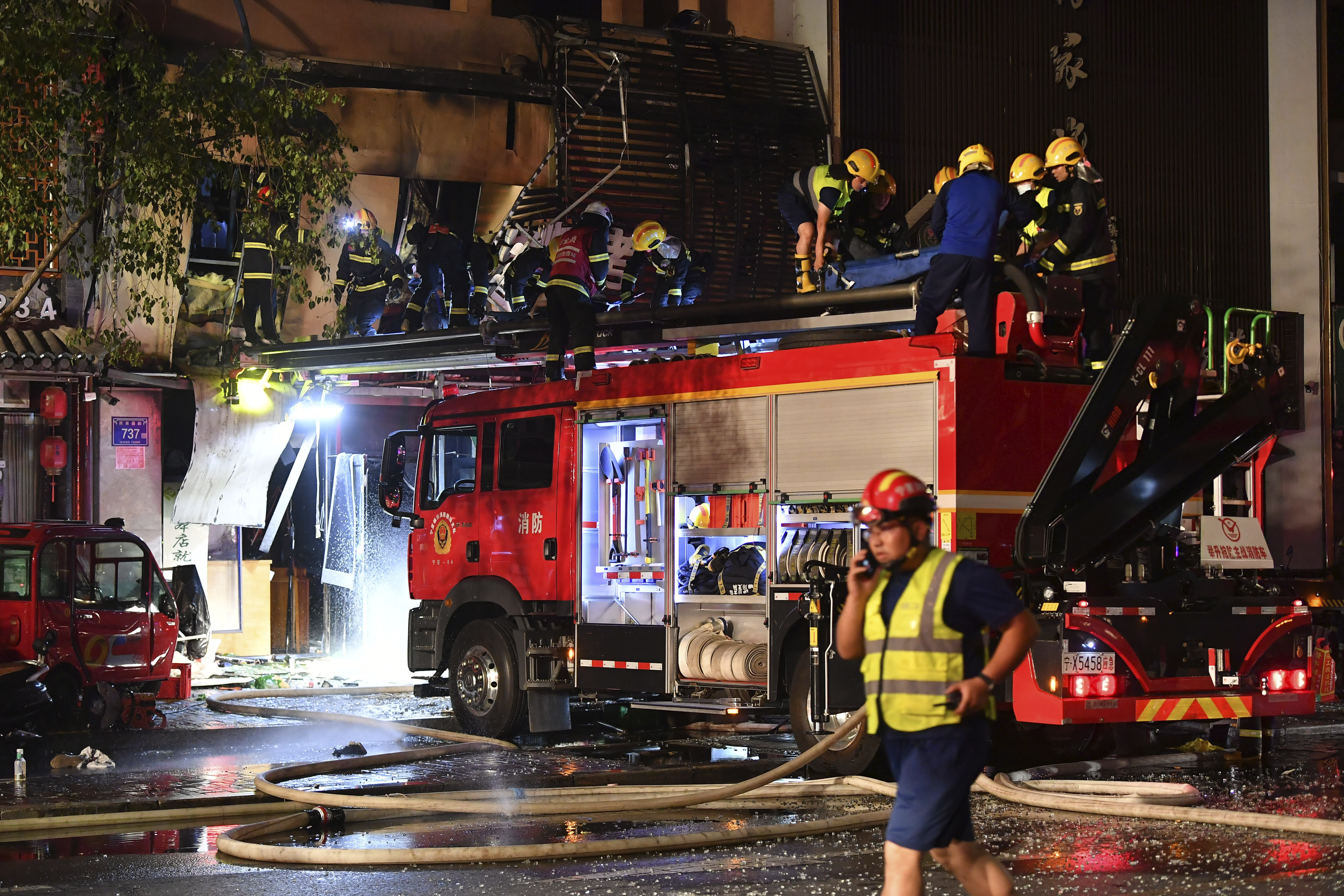 Firefighters work at the site of an explosion at a restaurant in Yinchuan, northwest China's Ningxia Hui Autonomous Region in the early hours of Wednesday. A massive cooking gas explosion killed dozens and injured some, Chinese authorities said Thursday. 