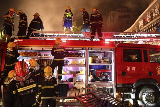 Firefighters work at the site of an explosion at a restaurant in Yinchuan, northwest China's Ningxia Hui Autonomous Region Wednesday. Cooking gas caused a massive explosion at a barbecue restaurant in northwestern China killed dozens and injured some, Chinese authorities said Thursday.