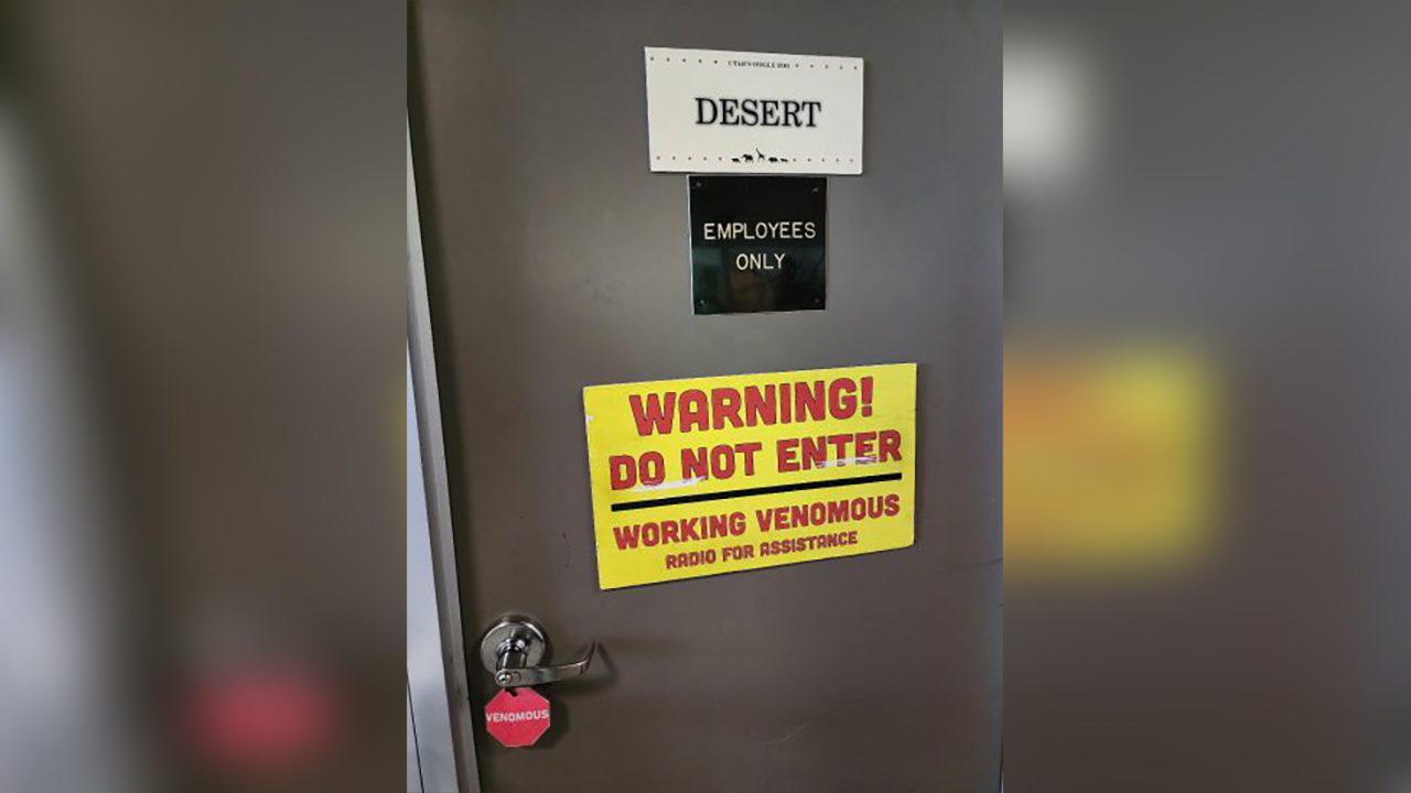 Safety signs are displayed outside a kitchen when venomous reptiles are being worked with at Utah's Hogle Zoo, in Salt Lake City.