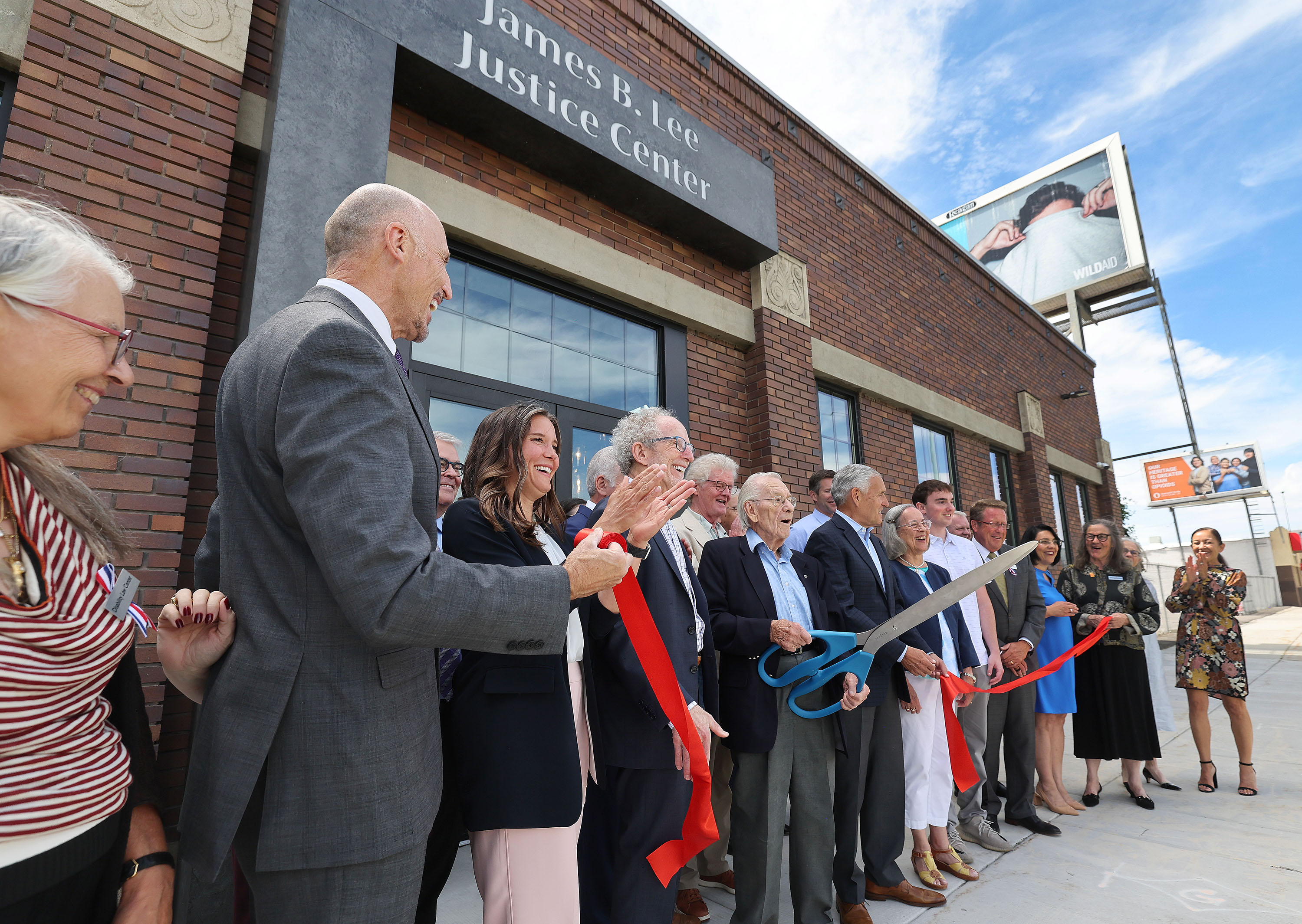 A ribbon is cut by Robert Graham, a member of the Florence J. Gillmor Foundation board of directors, at the James. B. Lee Justice Center in Salt Lake City on Thursday.