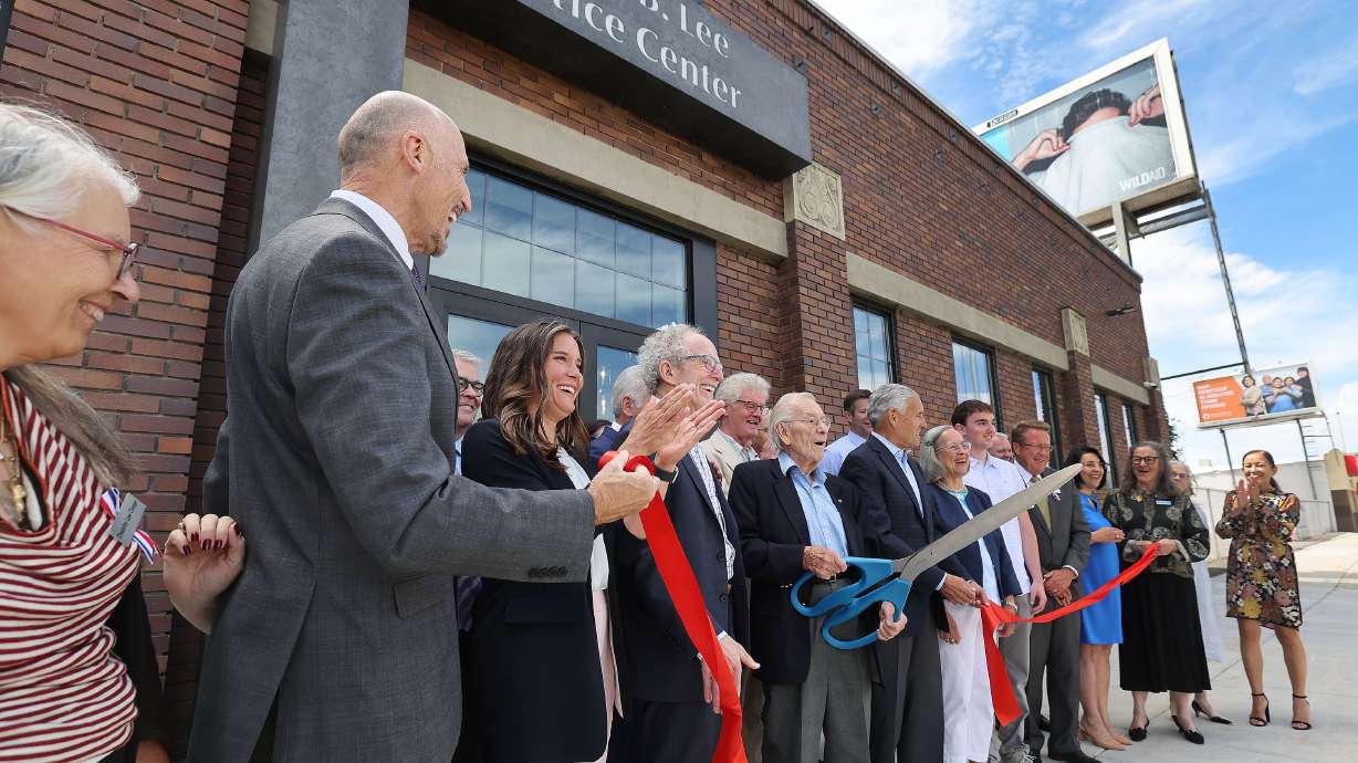 A ribbon is cut by Robert Graham, a member of the Florence J. Gillmor Foundation board of directors, at the James. B. Lee Justice Center in Salt Lake City on Thursday.