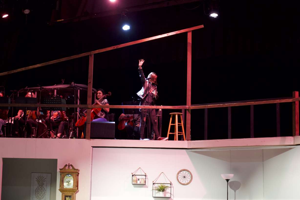 Lead singer Kjersti Long, 16, waves goodbye as she exits the stage at the end of the "Relative Space: An Atypical Musical" premiere in Pleasant Grove on Thursday.