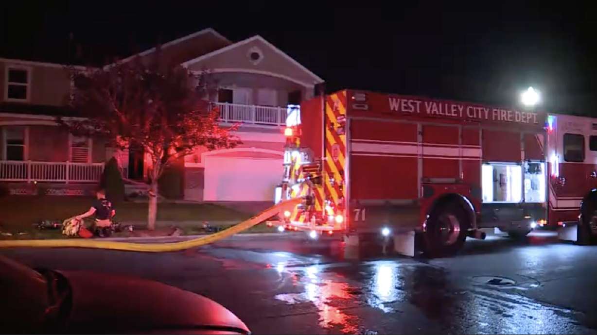 A family safely evacuated from their burning home in West Valley City early Friday.