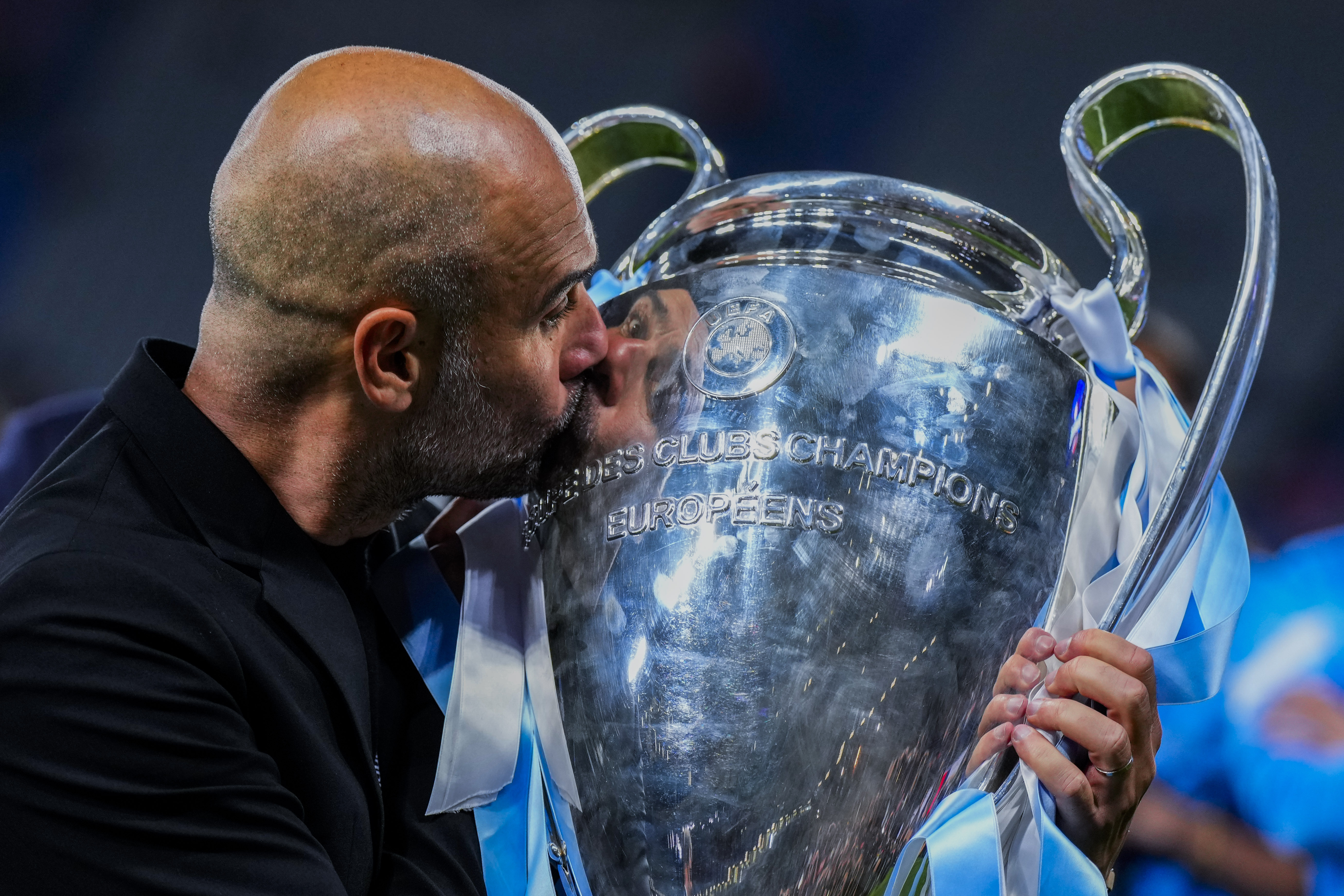 Manchester City's head coach Pep Guardiola kisses the trophy after winning the Champions League final soccer match between Manchester City and Inter Milan at the Ataturk Olympic Stadium in Istanbul, Turkey, Sunday, June 11, 2023. Manchester City won 1-0. 
