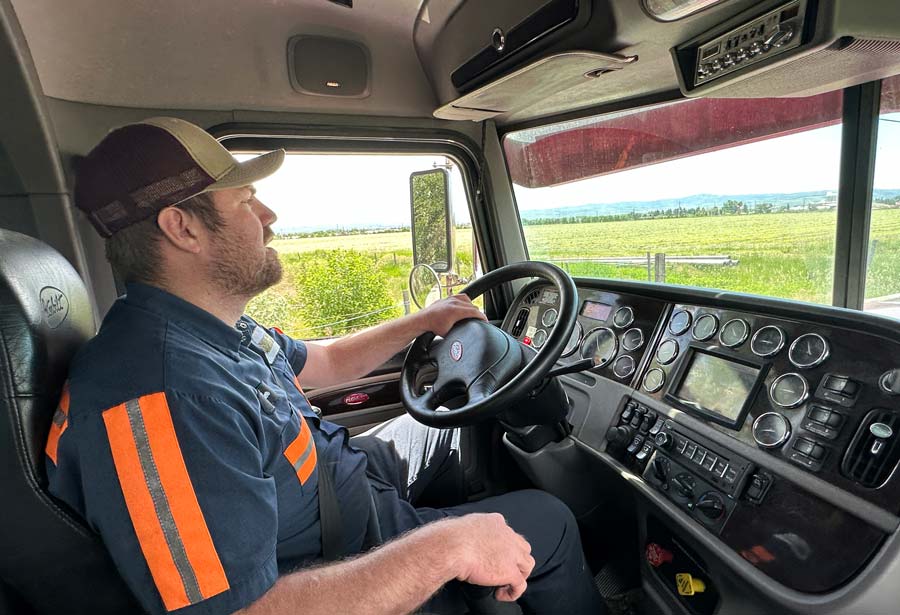 Tyler Pickering drives his tow truck. Pickering was being crushed by a garbage truck for 10 to 15 minutes before he was able to reach into his pocket for his cellphone and call for help.