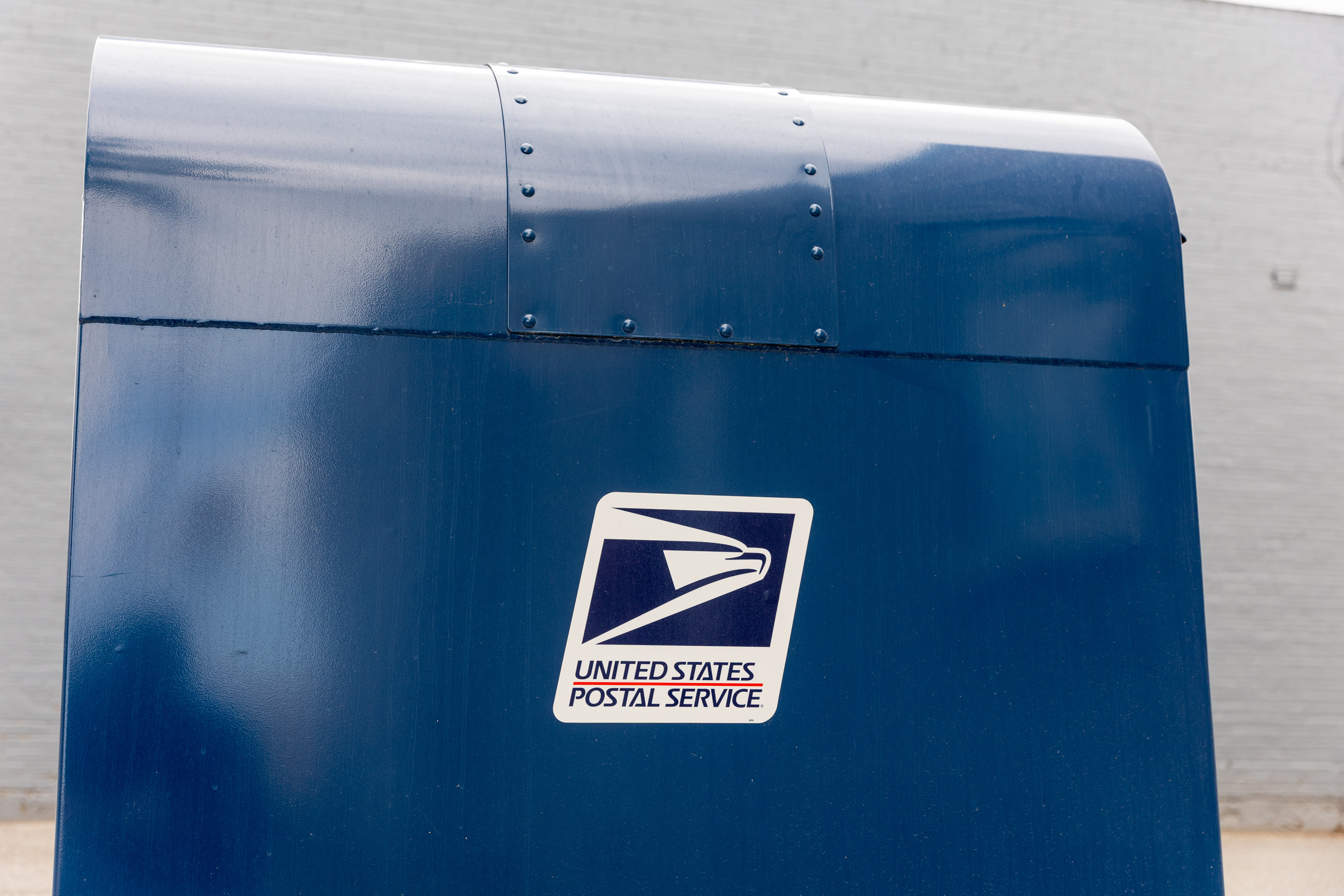 Two of three men who pleaded guilty to robbing a U.S. Post Office mail carrier at gunpoint were sentenced to federal prison on Friday.