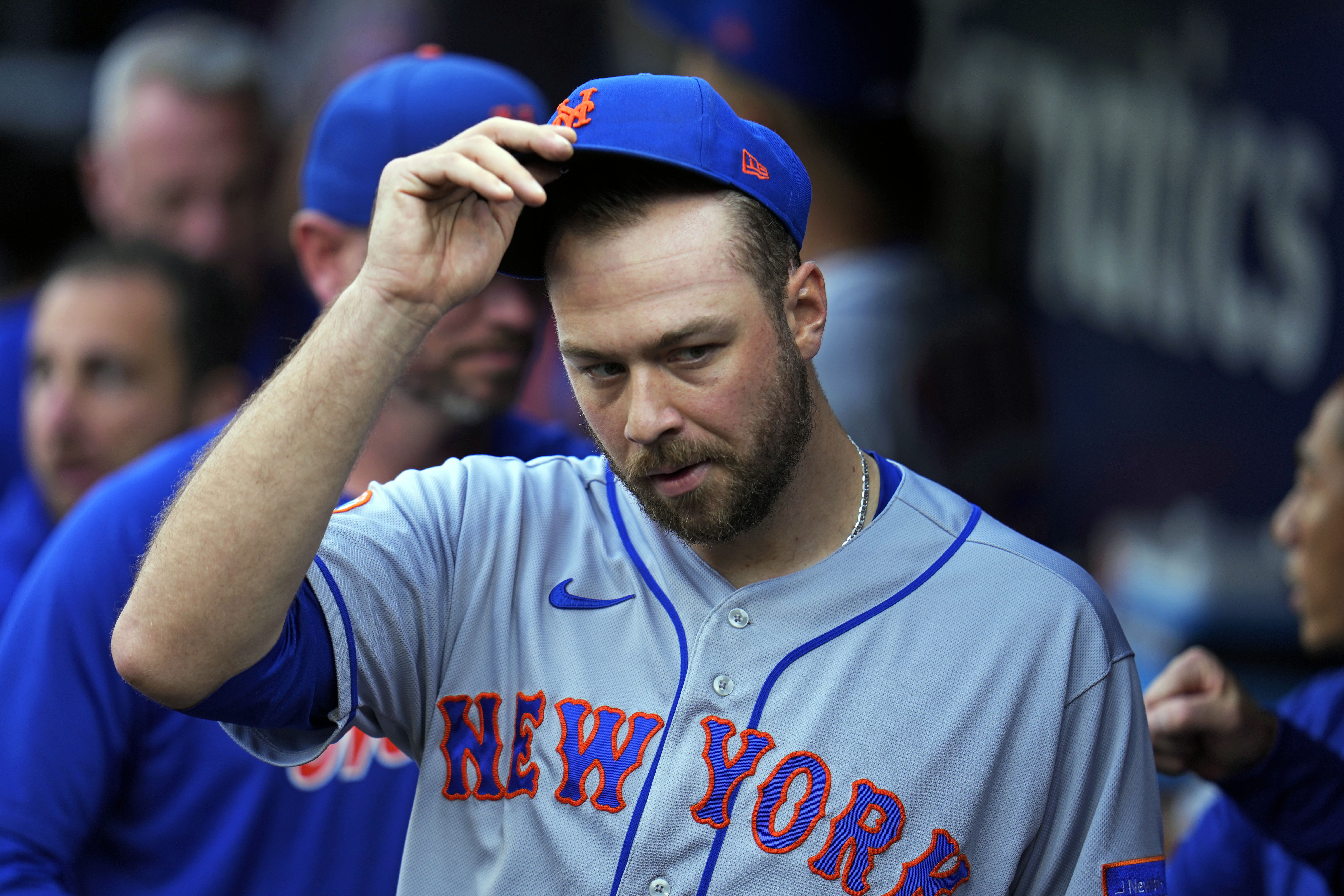 New York Mets starting pitcher Tylor Megill takes off his cap in the dugout before a baseball game against the Pittsburgh Pirates in Pittsburgh, Friday, June 9, 2023. 