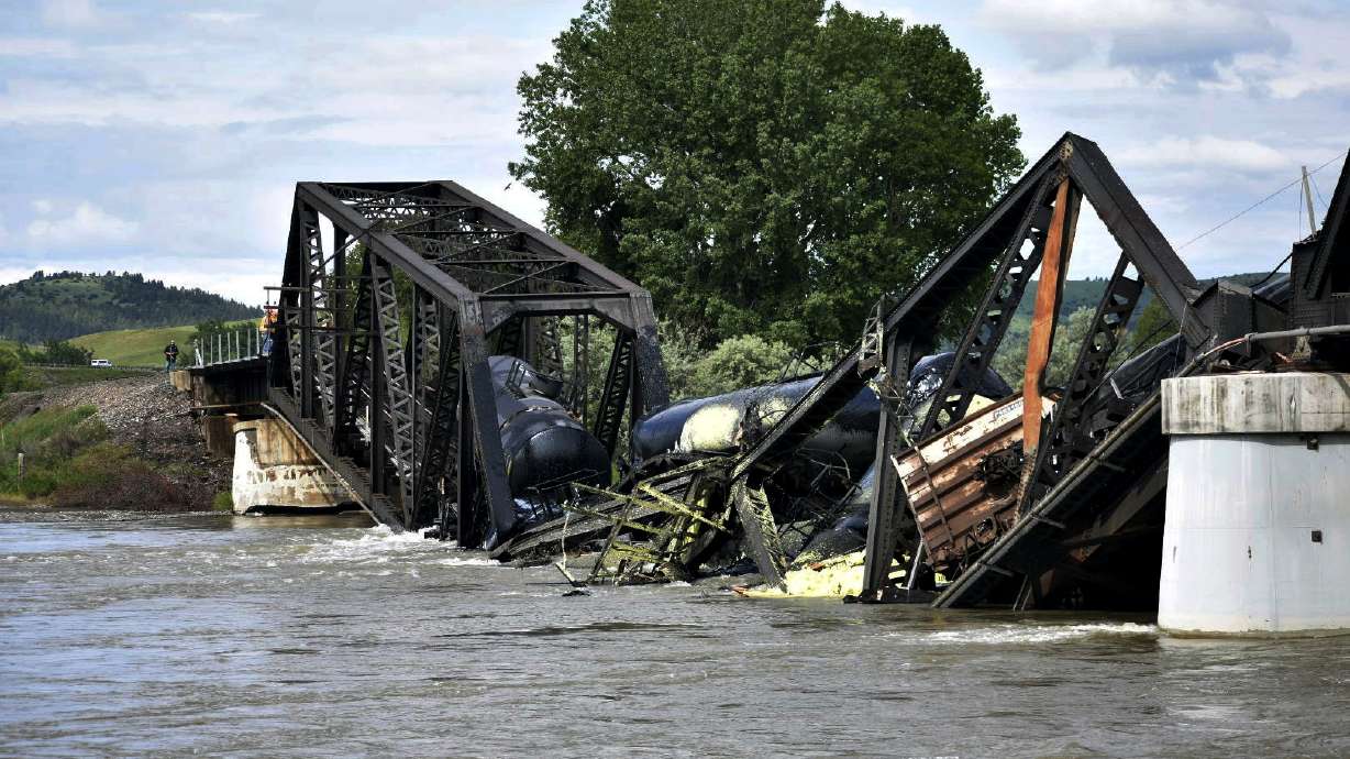 Several train cars are immersed in the Yellowstone River after a bridge collapse near Columbus, Montana, on Saturday. The bridge collapsed overnight, causing a train that was traveling over it to plunge into the water below.