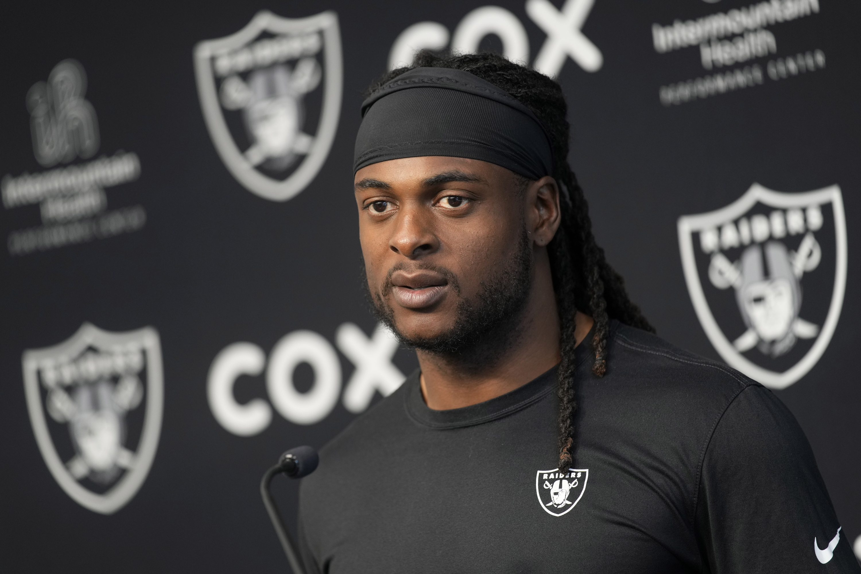FILE - Las Vegas Raiders wide receiver Davante Adams speaks during a news conference at the NFL football team's training facility Thursday, May 25, 2023, in Henderson, Nev. Prosecutors have dropped a misdemeanor assault charge filed last October against Adams after he shoved a photographer to the ground as he left the field following a loss at Kansas City. The case filed in Kansas City municipal court was dismissed June 5, the Kansas City Star reported.