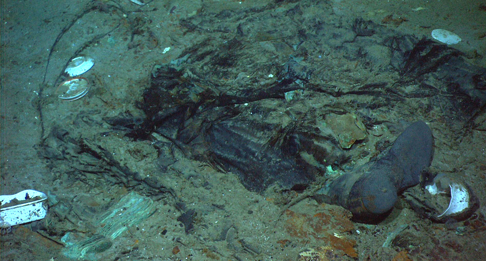 This 2004 photo shows the remains of a coat and boots in the mud on the sea bed near the Titanic's stern. The wrecks of the Titanic and the Titan sit on the ocean floor, separated by 1,600 feet and 111 years of history. How they came together unfolded over an intense week that raised temporary hopes and left lingering questions. 
