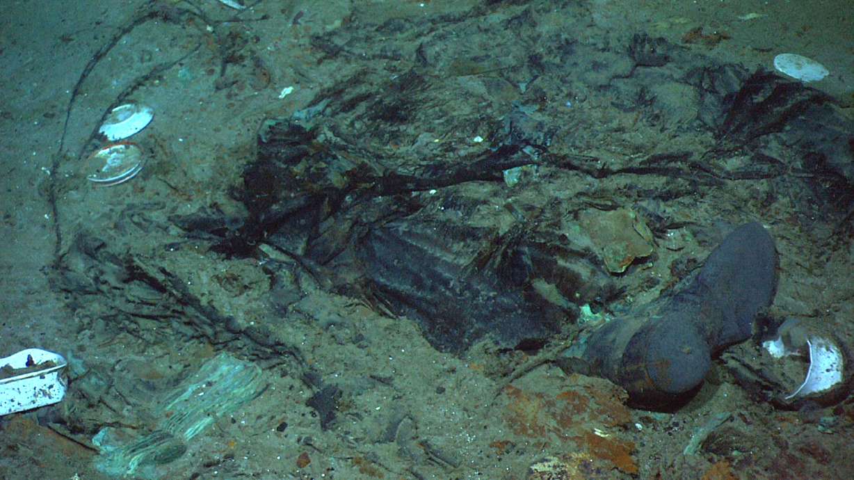 This 2004 photo shows the remains of a coat and boots in the mud on the sea bed near the Titanic's stern. The wrecks of the Titanic and the Titan sit on the ocean floor, separated by 1,600 feet and 111 years of history. How they came together unfolded over an intense week that raised temporary hopes and left lingering questions.