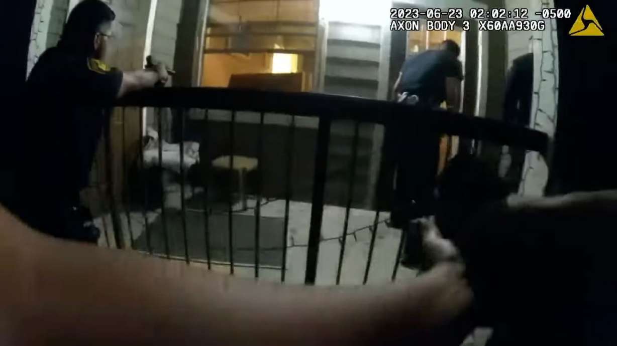 A still from body camera video shows police firing into the apartment of Melissa Ann Perez. Three San Antonio police officers were charged with murder on Friday, less than 24 hours after they fatally shot Perez during a police call.