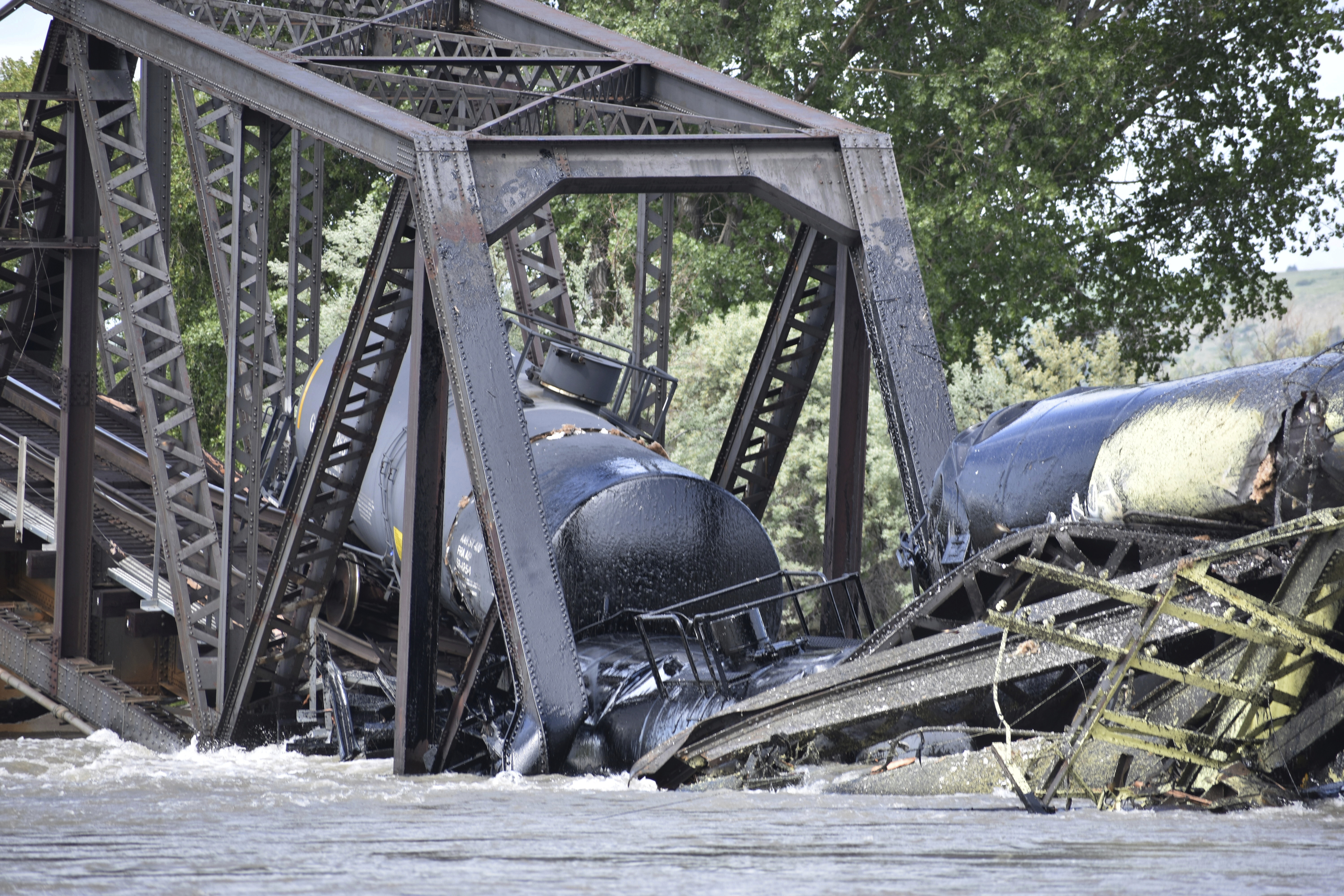 Authorities on Sunday were testing the water quality along a stretch of the Yellowstone River where mangled train cars carrying hazardous materials remained after crashing into the waterway.