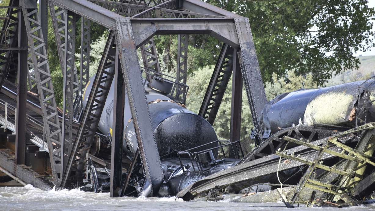 Authorities on Sunday were testing the water quality along a stretch of the Yellowstone River where mangled train cars carrying hazardous materials remained after crashing into the waterway.