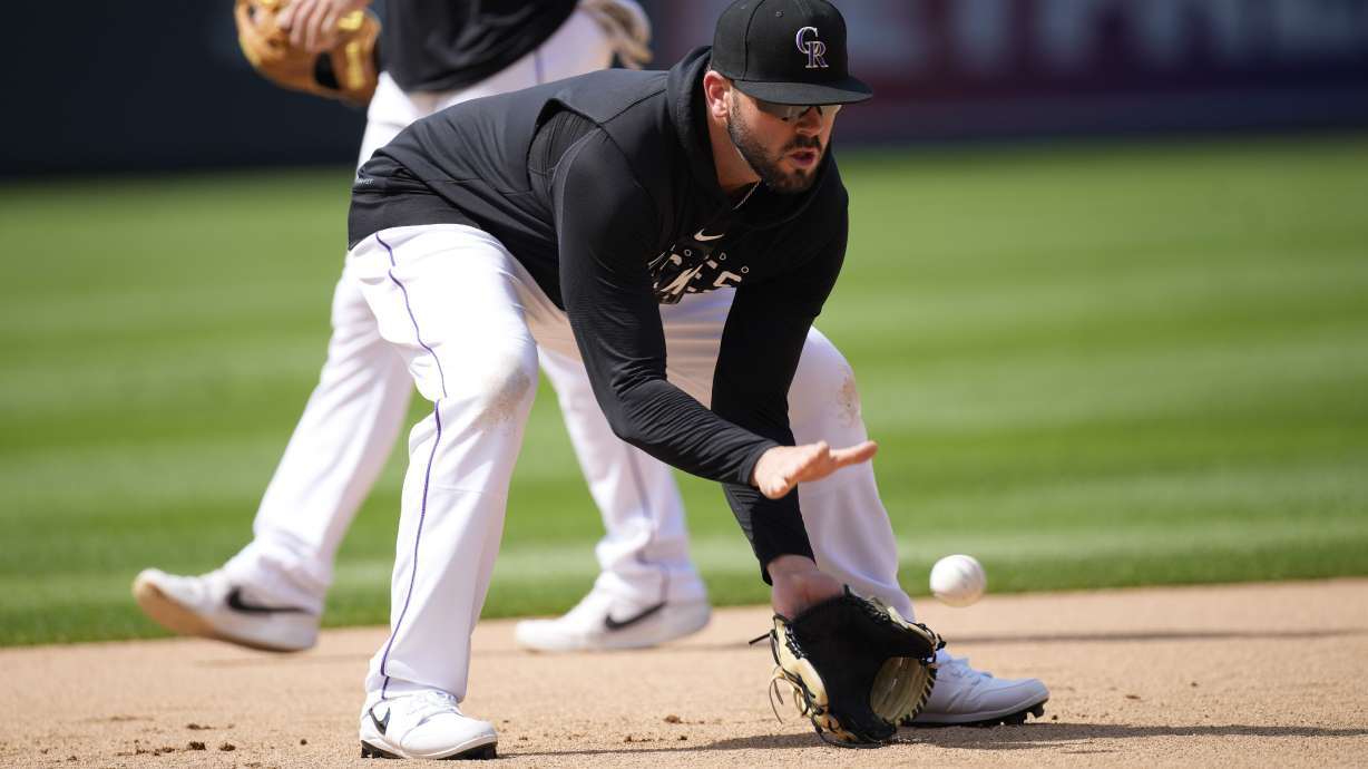 Colorado Rockies first baseman Mike Moustakas warms up for the team's baseball game against the Los Angeles Angels on Friday, June 23, 2023, in Denver.