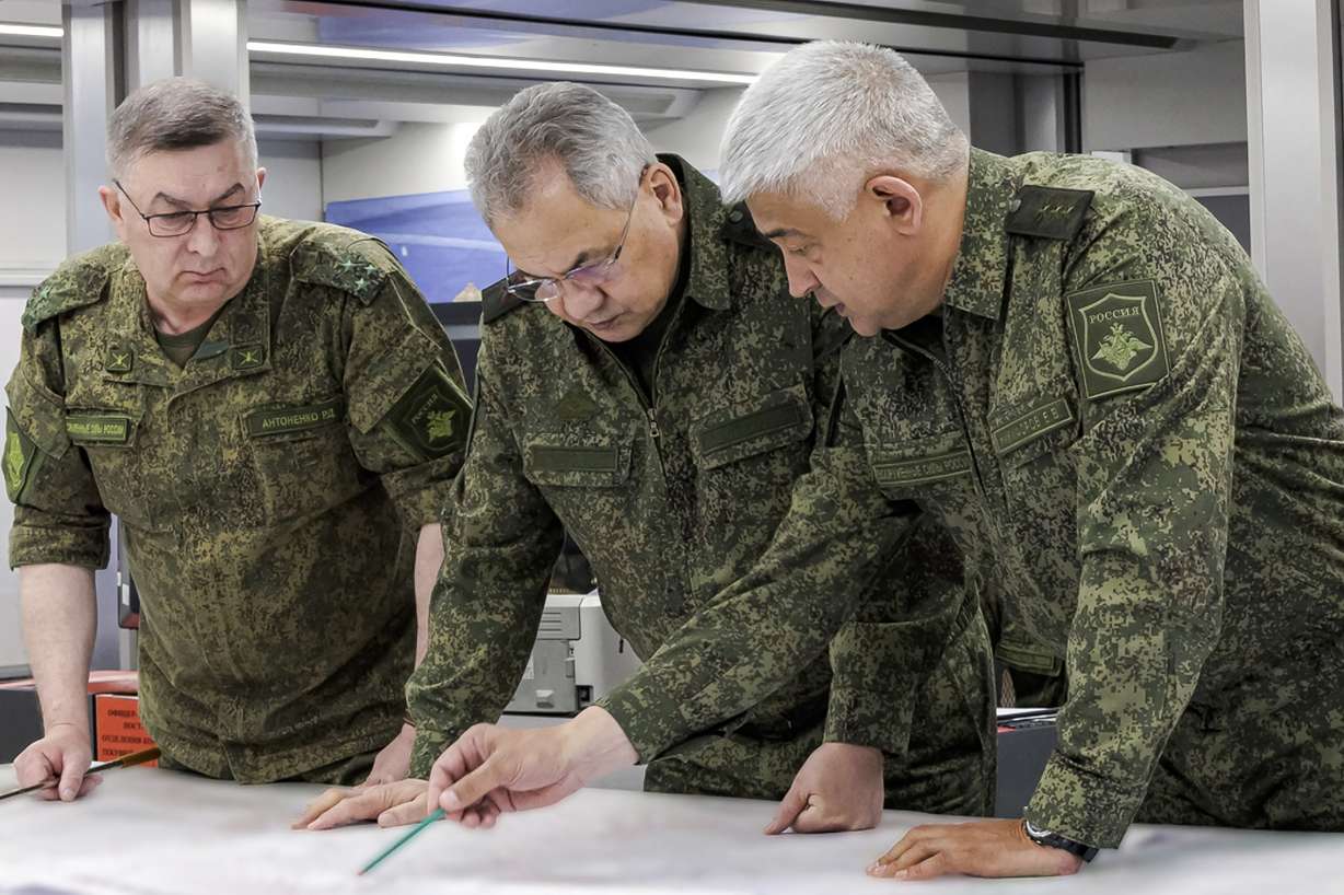 In this photo released on Monday by the Russian Defense Ministry Press Service, Russian Defense Minister Sergei Shoigu, center, and Yevgeny Nikiforov, the commander of the Western Military District, right, inspect a command post of one of the formations of the Zapad (West) group of Russian troops at an undisclosed location of Ukraine.