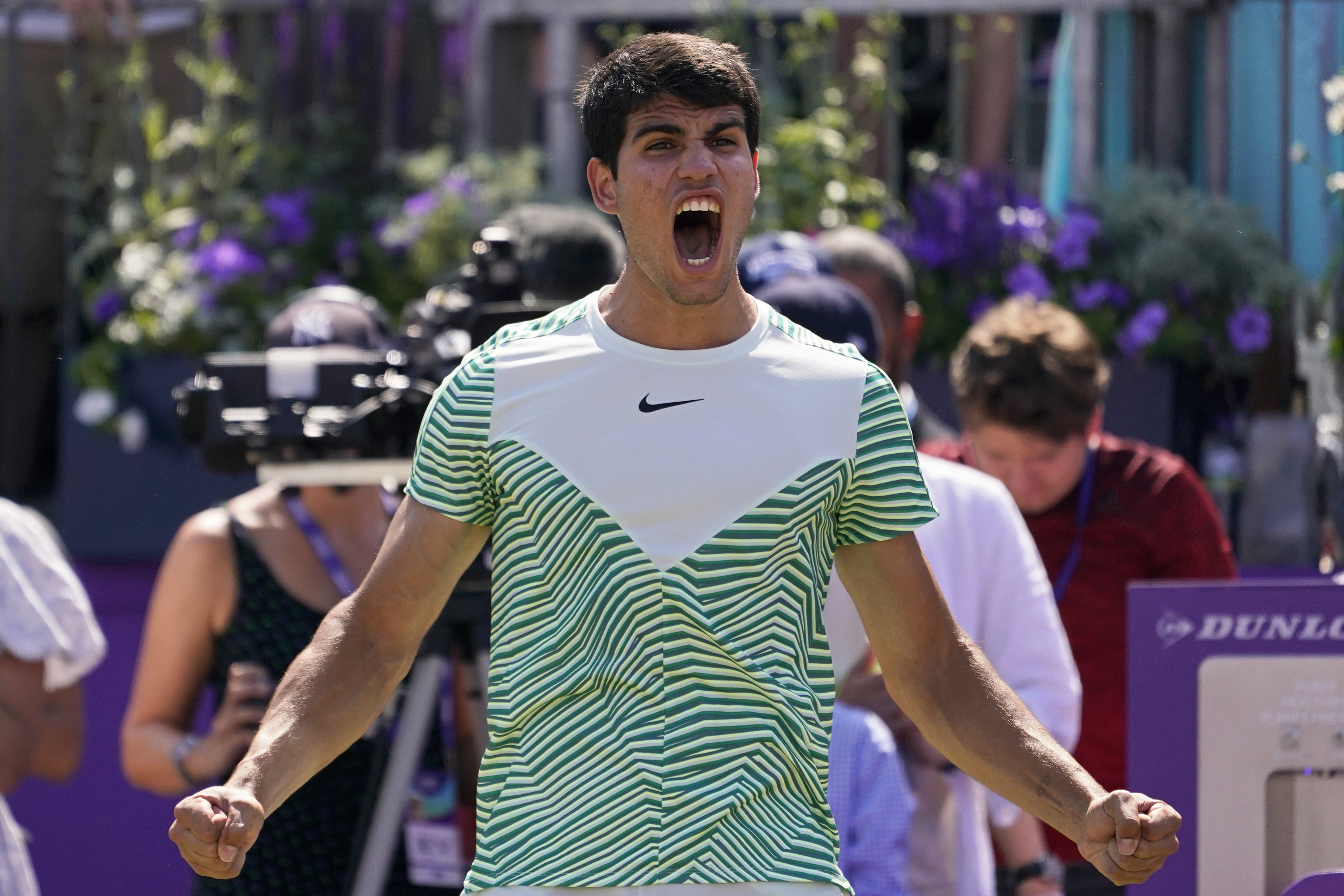 Carlos Alcaraz, of Spain, celebrates after defeating Alex de Minaur, of Australia, 6/4, 6/4 in their mens singles final match at the Queens Club tennis tournament in London, Sunday, June 25, 2023.