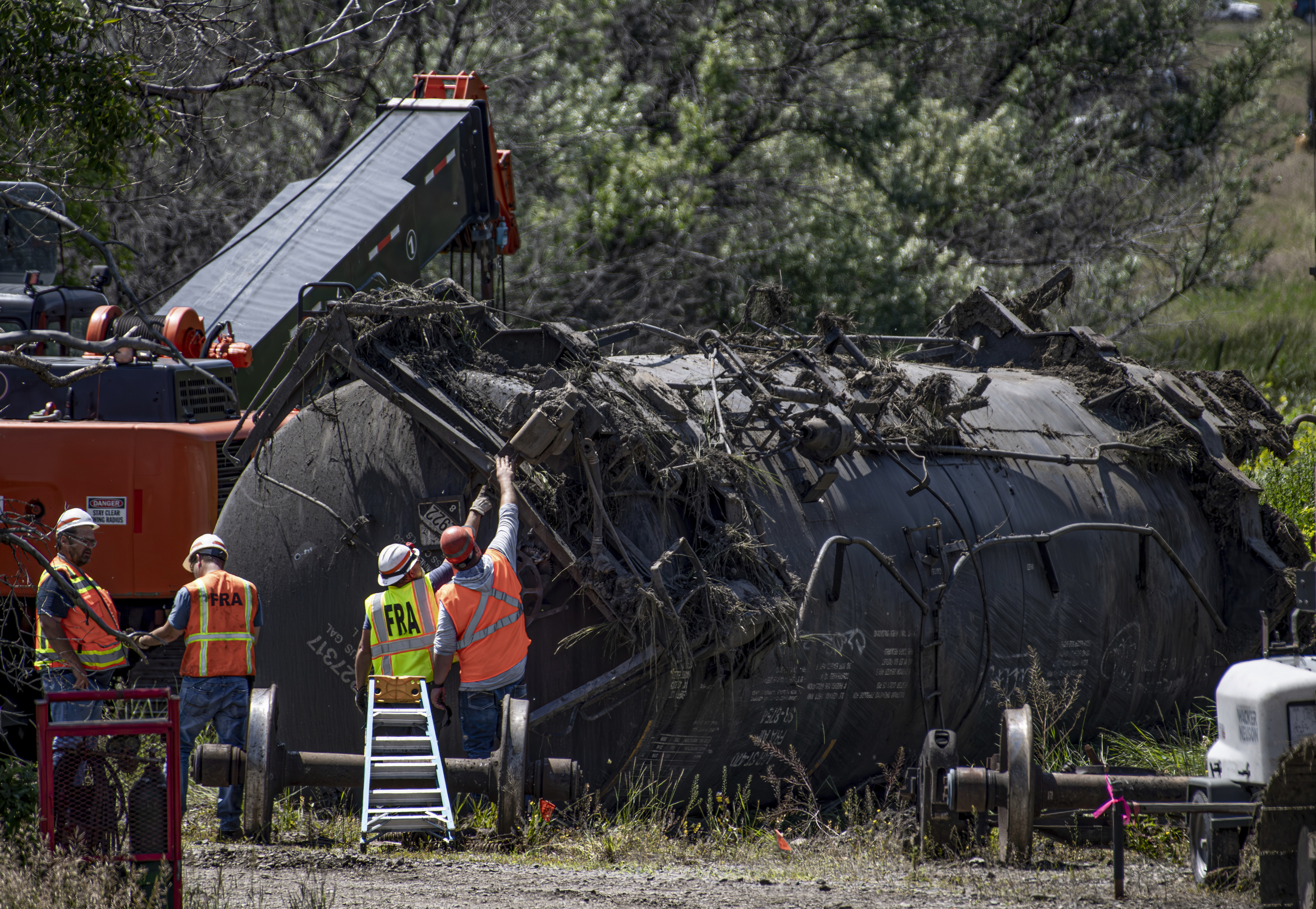 Crews work at the site of a railroad bridge collapse on the Yellowstone River near Reed Point on Sunday in Columbus, Mont.