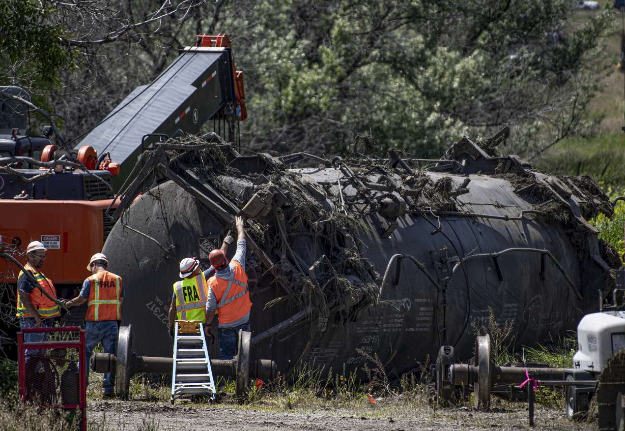 Crews work at the site of a railroad bridge collapse on the Yellowstone River near Reed Point on Sunday in Columbus, Mont.