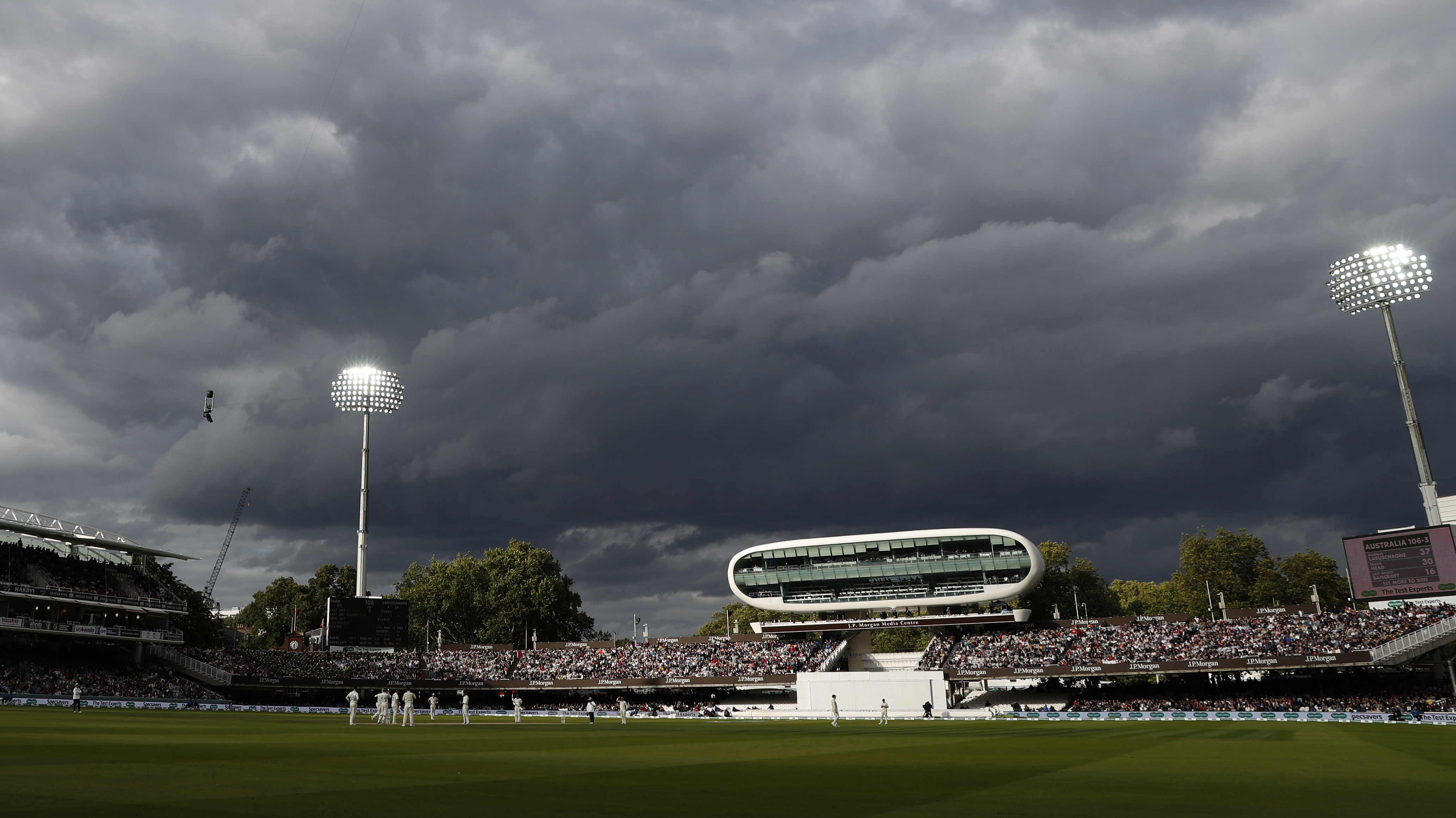 FILE - England's Jack Leach bowls to Australia's Marnus Labuschagne as dark clouds come over the ground during play on day five of the 2nd Ashes Test cricket match between England and Australia at Lord's cricket ground in London, Sunday, Aug. 18, 2019. An independent commission has found that institutional racism, sexism and class-based discrimination continue to infect English cricket. A long-awaited report into the state of the sport was published by the Independent Commission for Equity in Cricket (ICEC). It found that reform was needed to "tackle discrimination, remove barriers and reform the game to make cricket more inclusive." 
