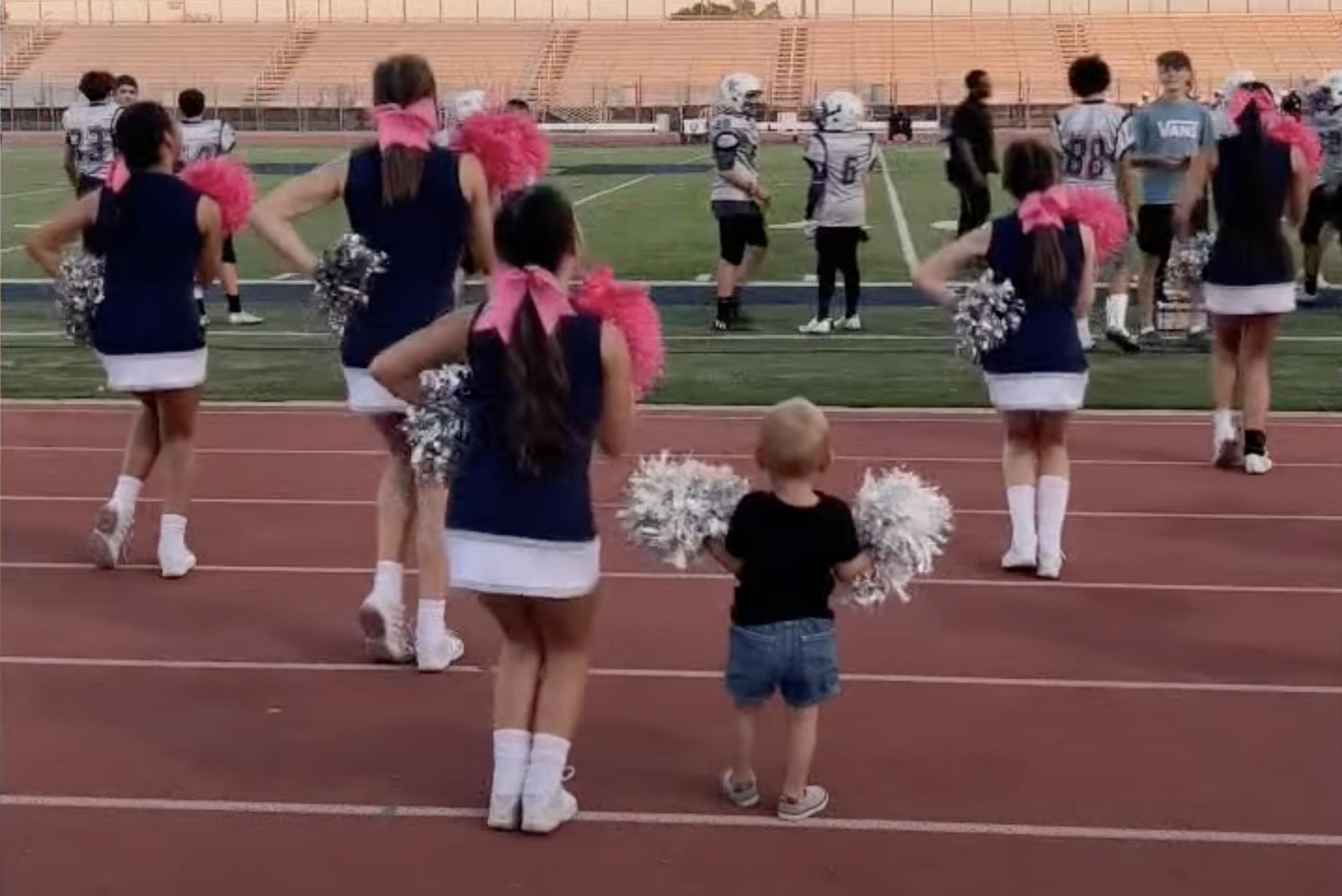 Two-year-old Liam from Pflugerville, Texas, has all the moves down to accompany his sister’s middle school cheerleading squad.