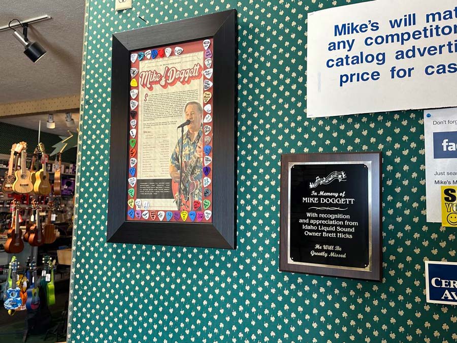 The framed picture of Mike is inside the music store.