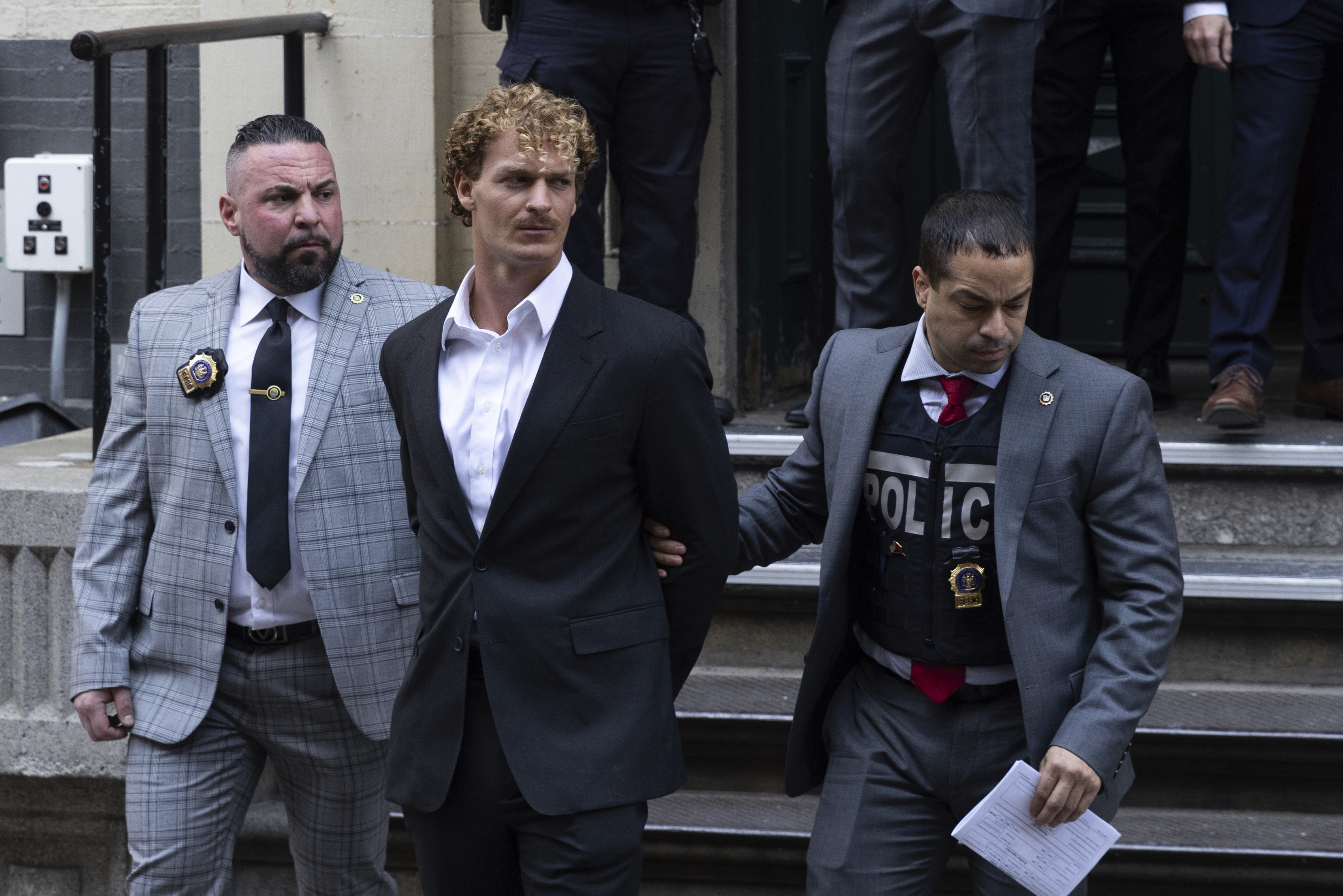 Daniel Penny, center, is walked by New York Police detectives out of the 5th Precinct, May 12 in New York. Penny, the man charged with manslaughter for putting an agitated New York City subway rider in a fatal chokehold, pleaded not guilty Wednesday.