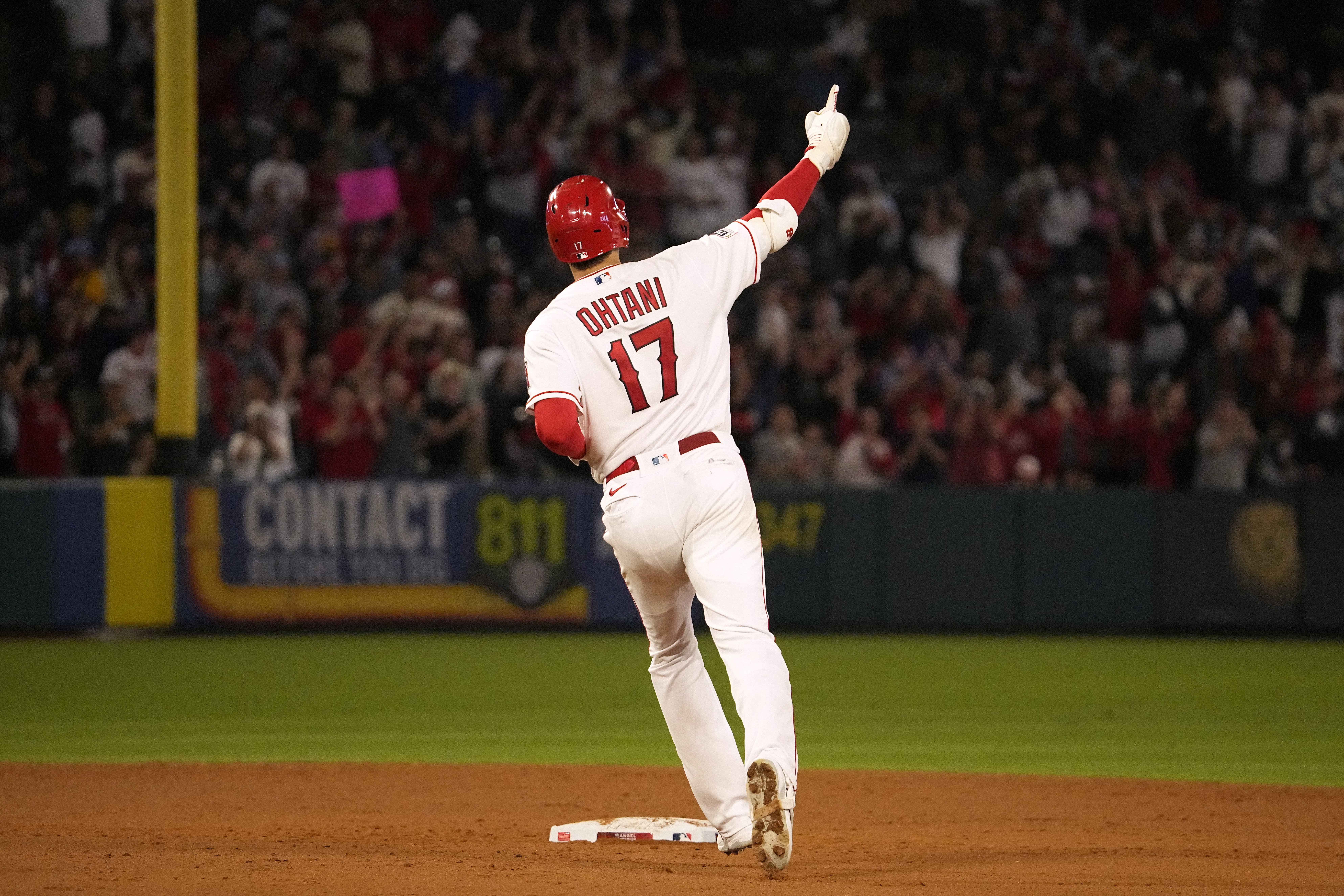 Los Angeles Angels' Shohei Ohtani celebrates as he rounds second after hitting a solo home run during the seventh inning of a baseball game against the Chicago White Sox Tuesday, June 27, 2023, in Anaheim, Calif. 